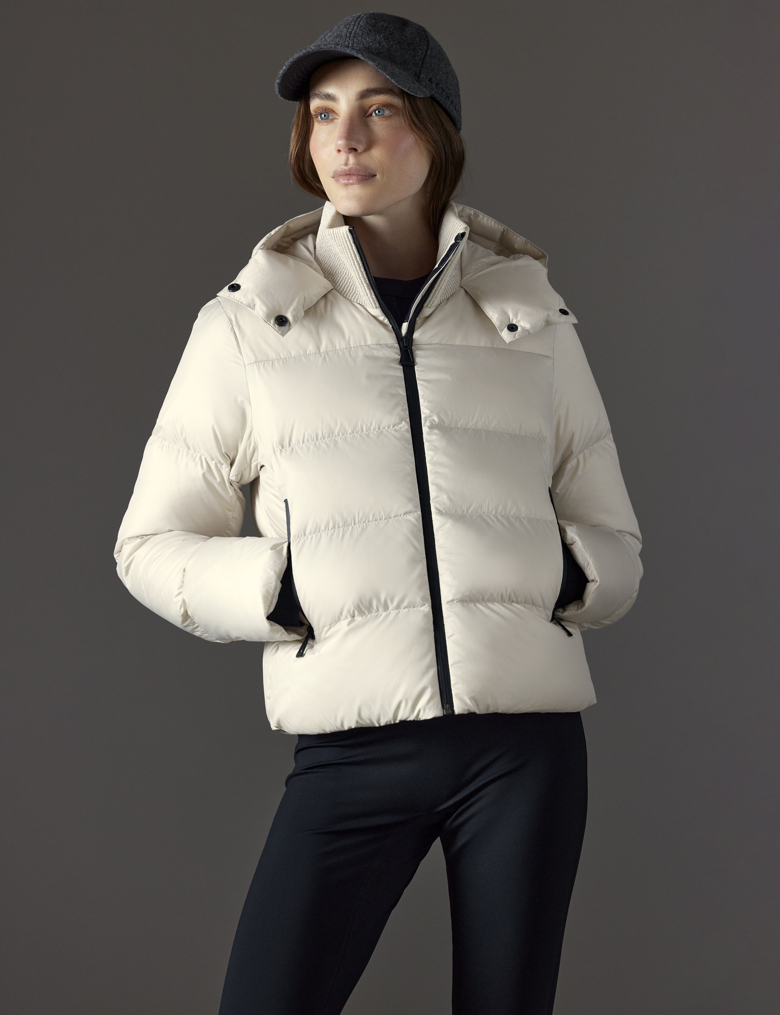 Front body view of woman wearing Aura Puffer Jacket in Bone white from AETHER Apparel.