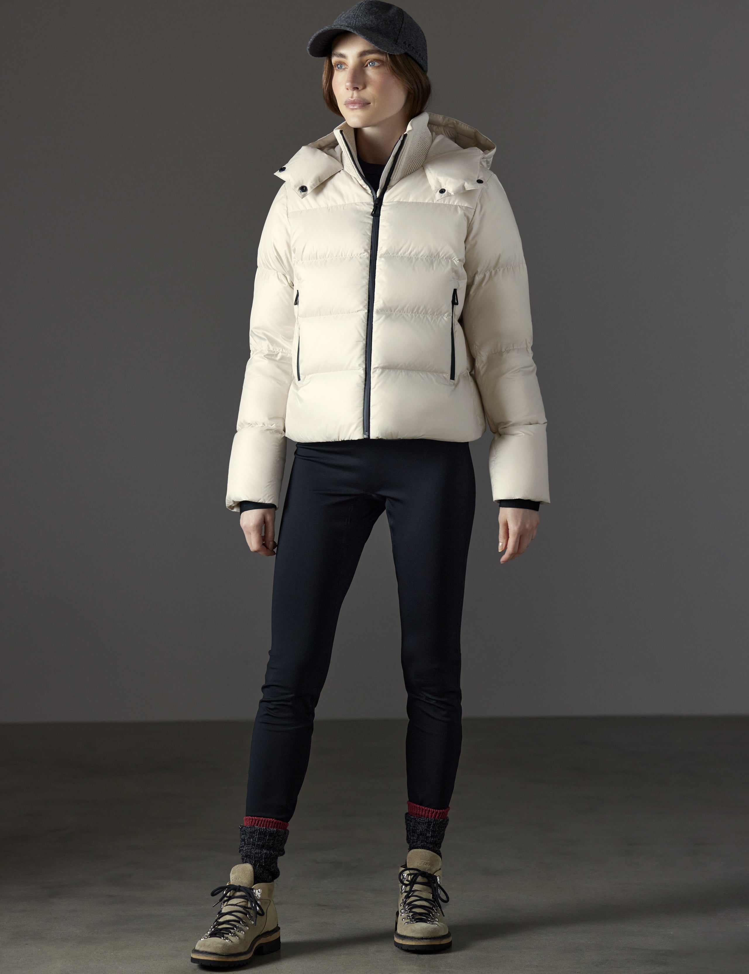 Front full-body view of woman wearing Aura Puffer Jacket in Bone white from AETHER Apparel.
