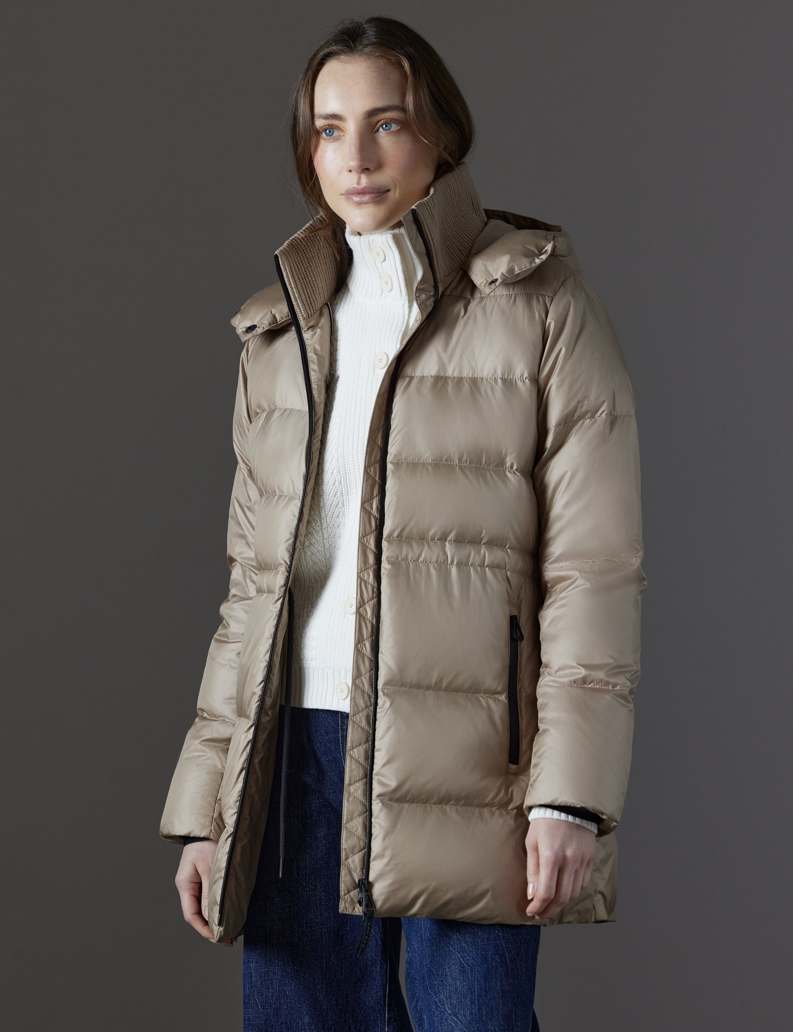 Front angled view of woman wearing unzipped Aura Puffer Long in Chinchilla Brown from AETHER Apparel.