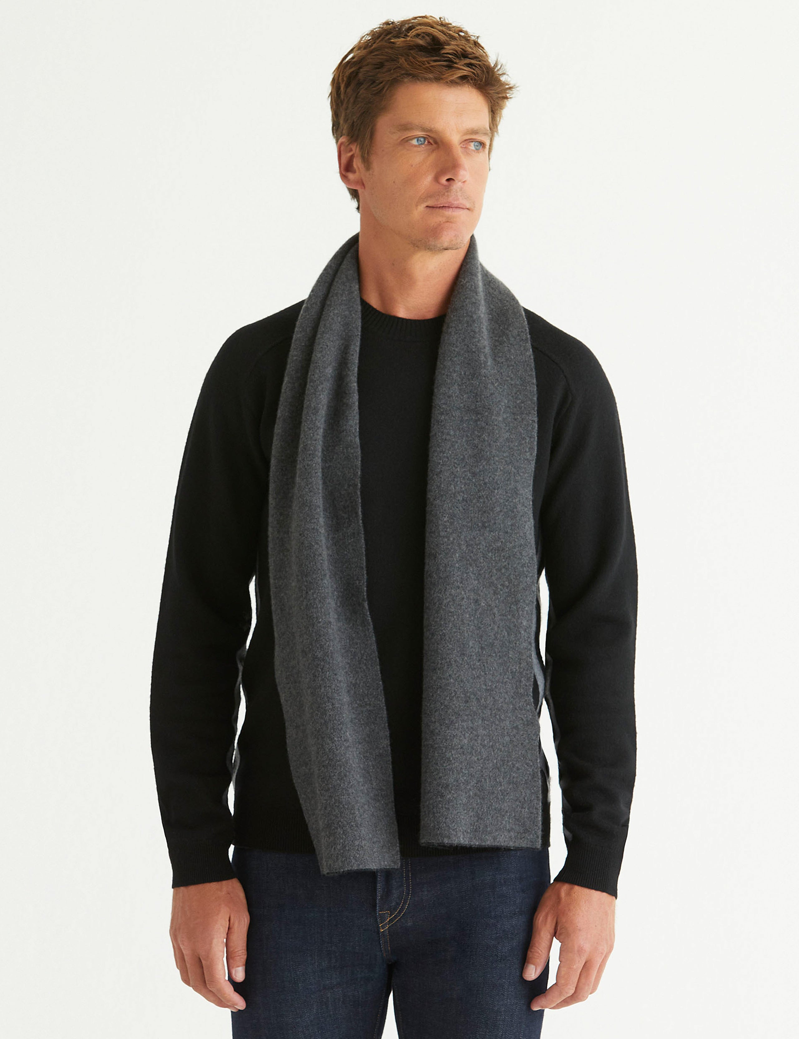 Front full-body view of man wearing Avesta Cashmere Scarf in Onyx Black from AETHER Apparel.