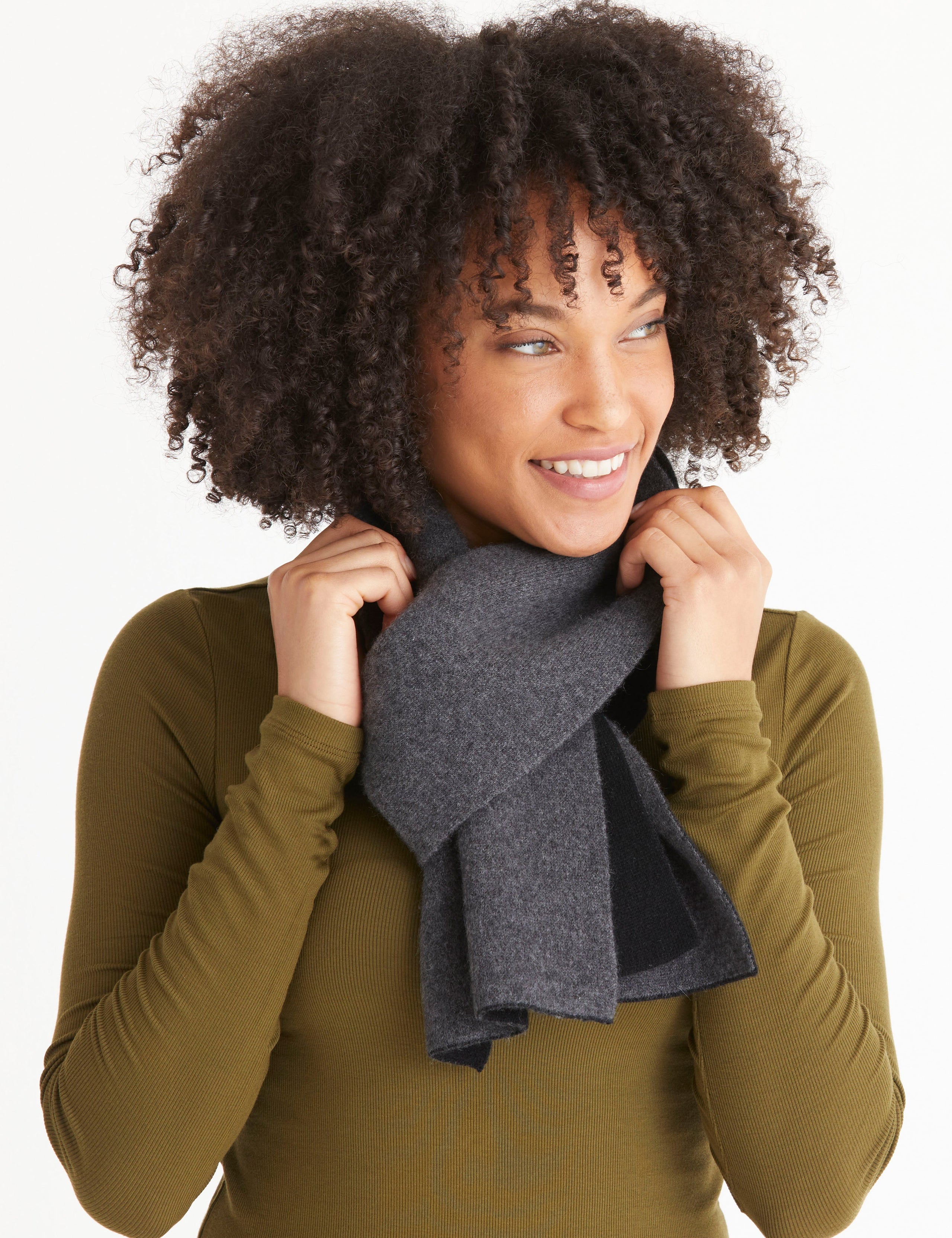 Front view of woman wearing Avesta Cashmere Scarf in Onyx Black from AETHER Apparel.