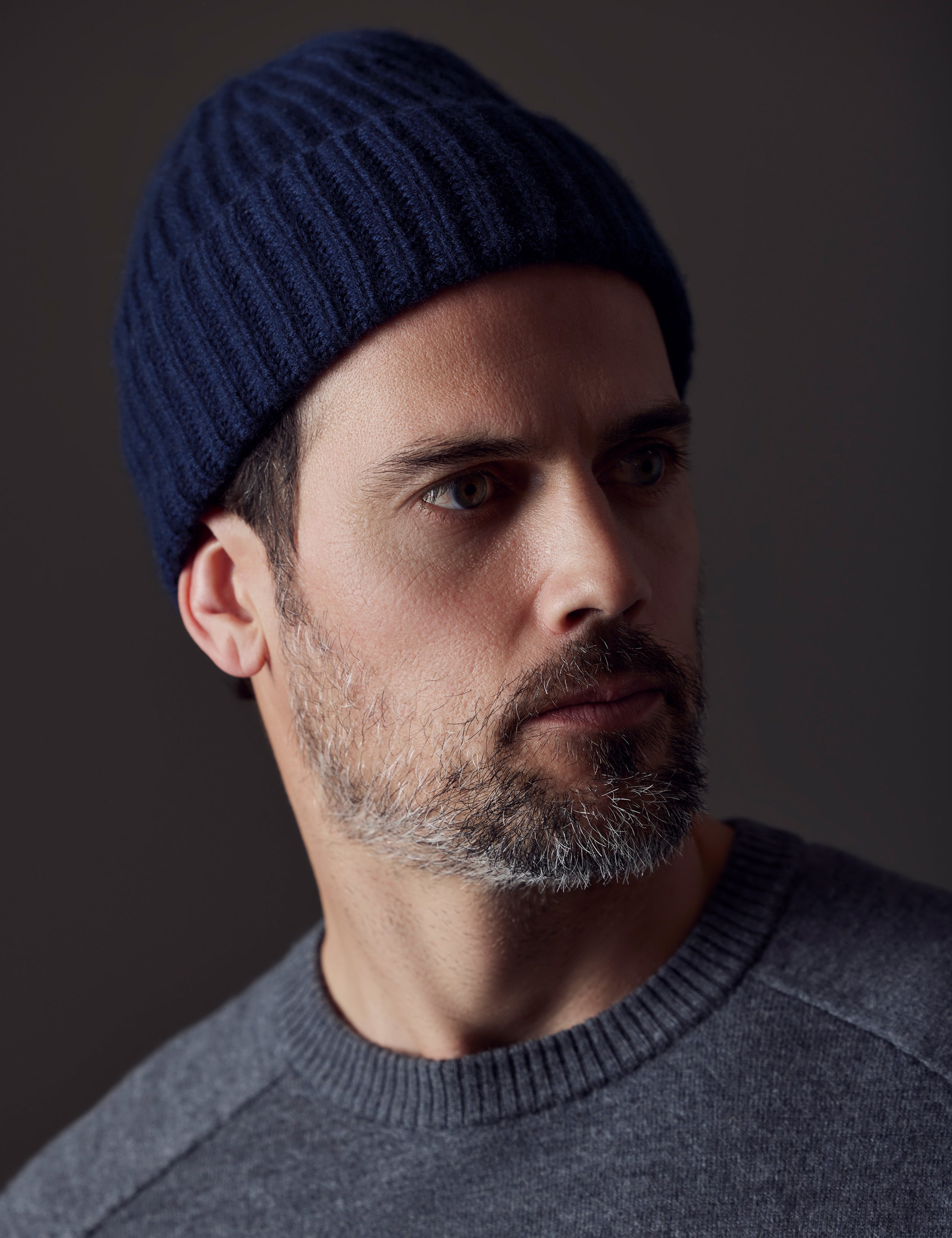 Front angled view of man wearing Cashmere Hat in Total Eclipse Dark Blue from AETHER Apparel. 