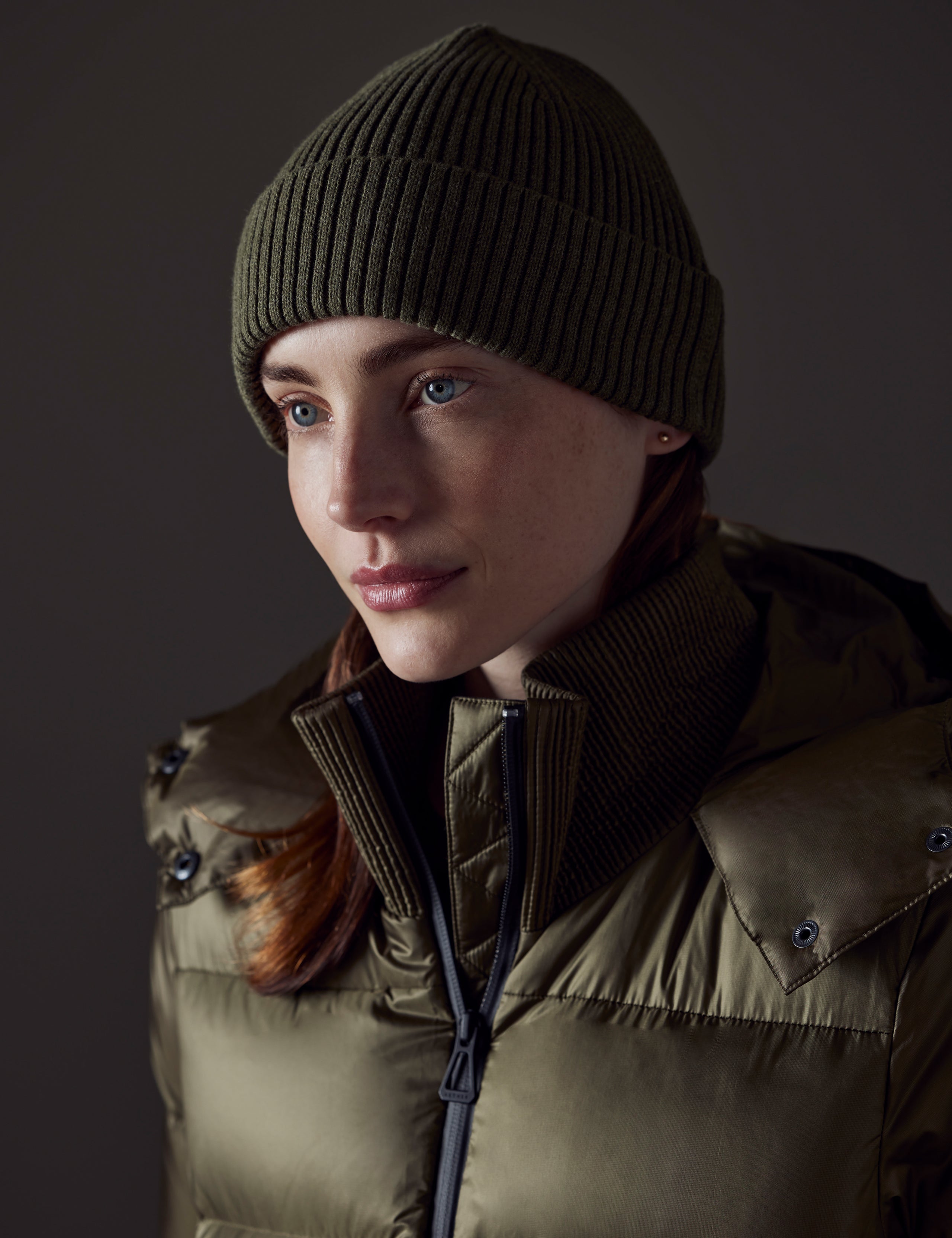 Front angled view of woman wearing Chalet Cotton Beanie in Command Green Heather from AETHER Apparel. 