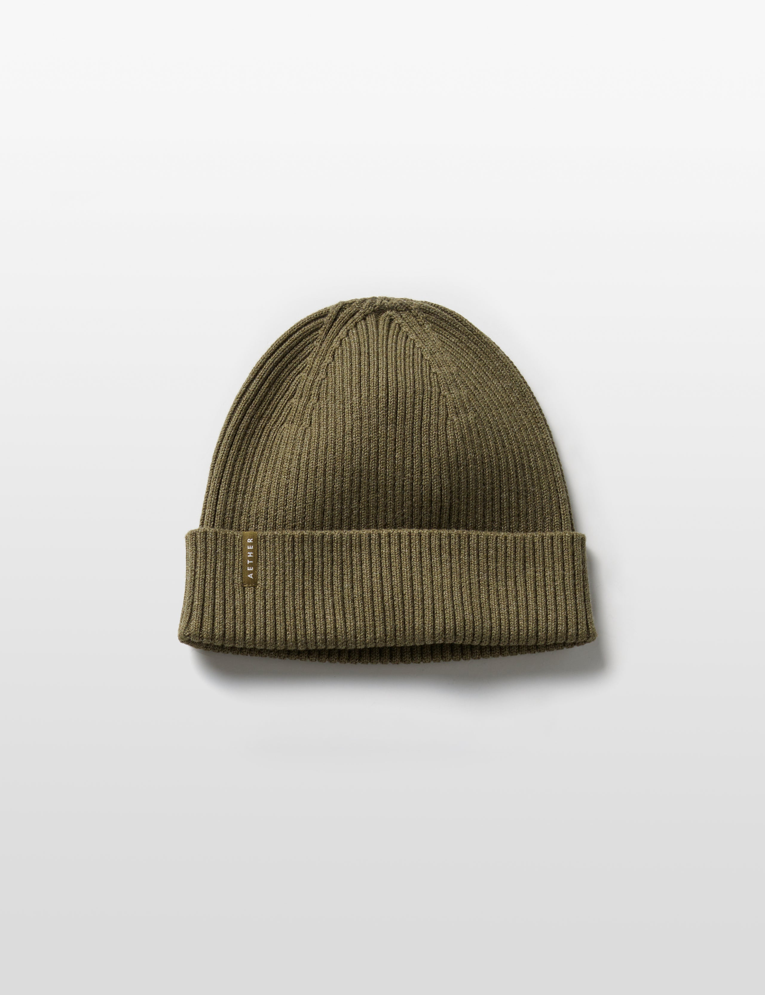 Flat lay of Chalet Cotton Beanie in Command Green Heather from AETHER Apparel. 