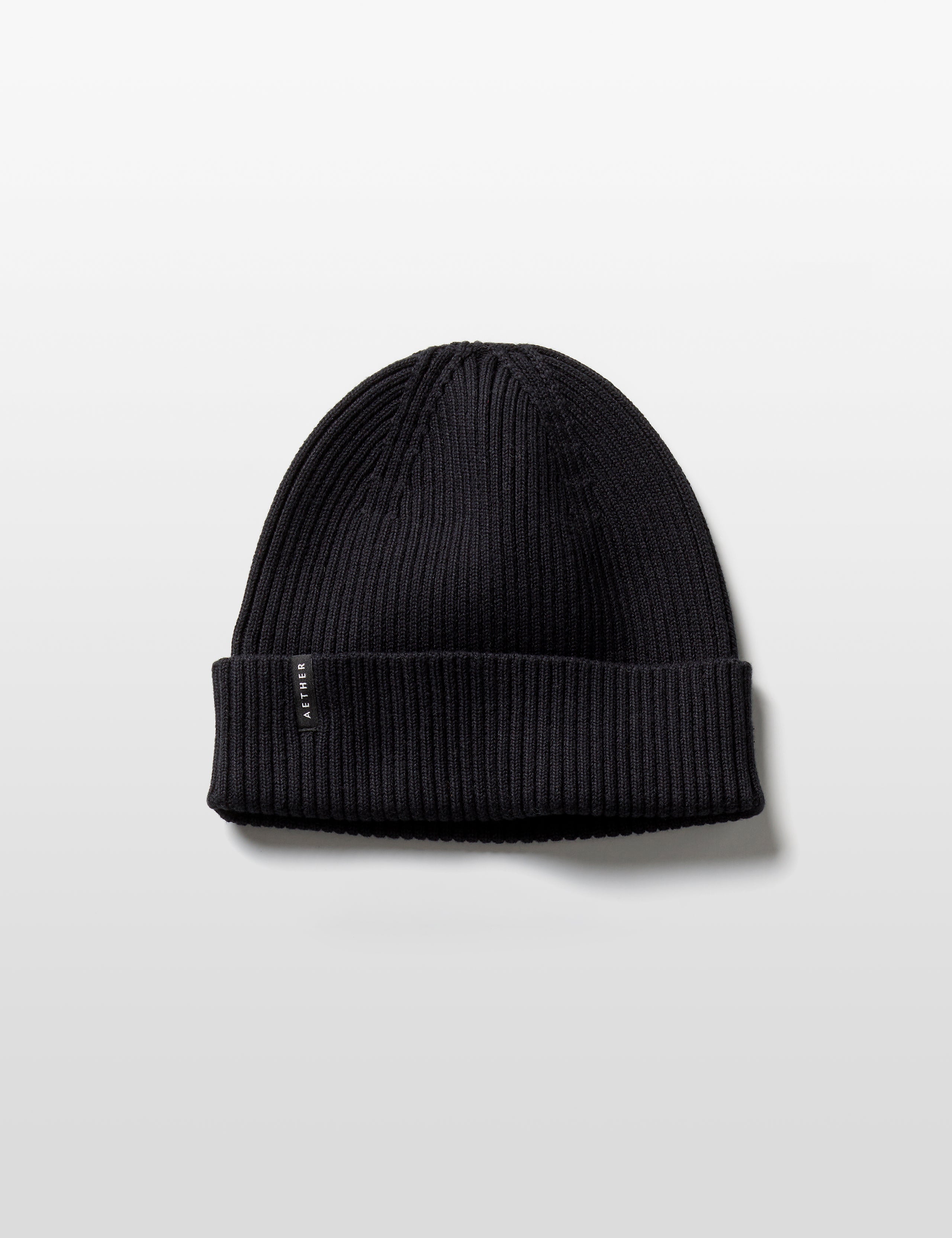 Flat lay of Chalet Cotton Beanie in Onyx Black from AETHER Apparel. 