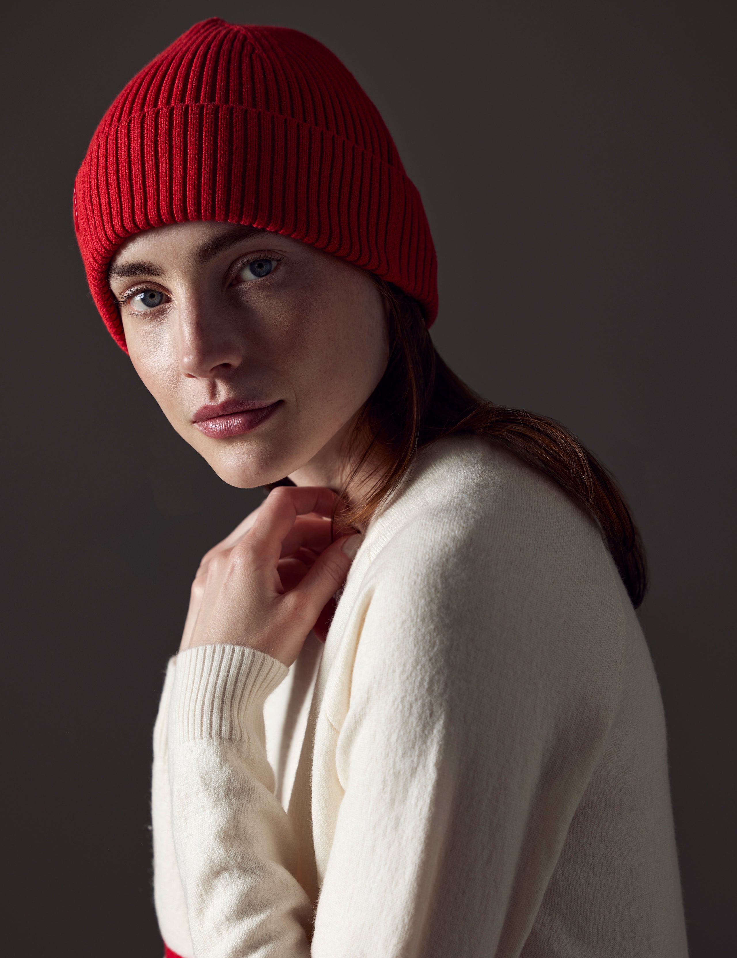 Front angled view of woman wearing Chalet Cotton Beanie in Racing Red from AETHER Apparel. 