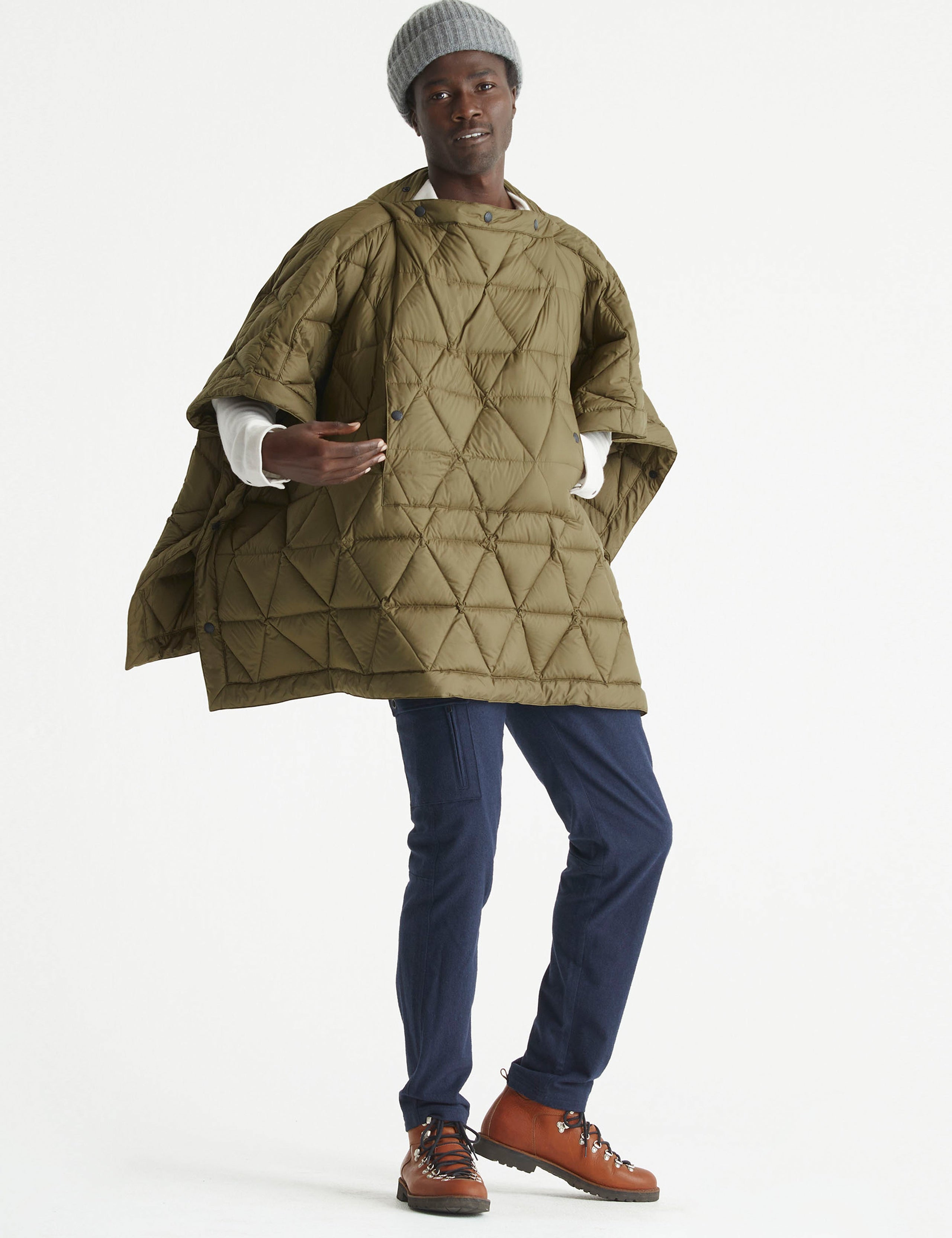 Front 3/4 full-body view of man wearing Down Poncho in Command Green from AETHER Apparel.