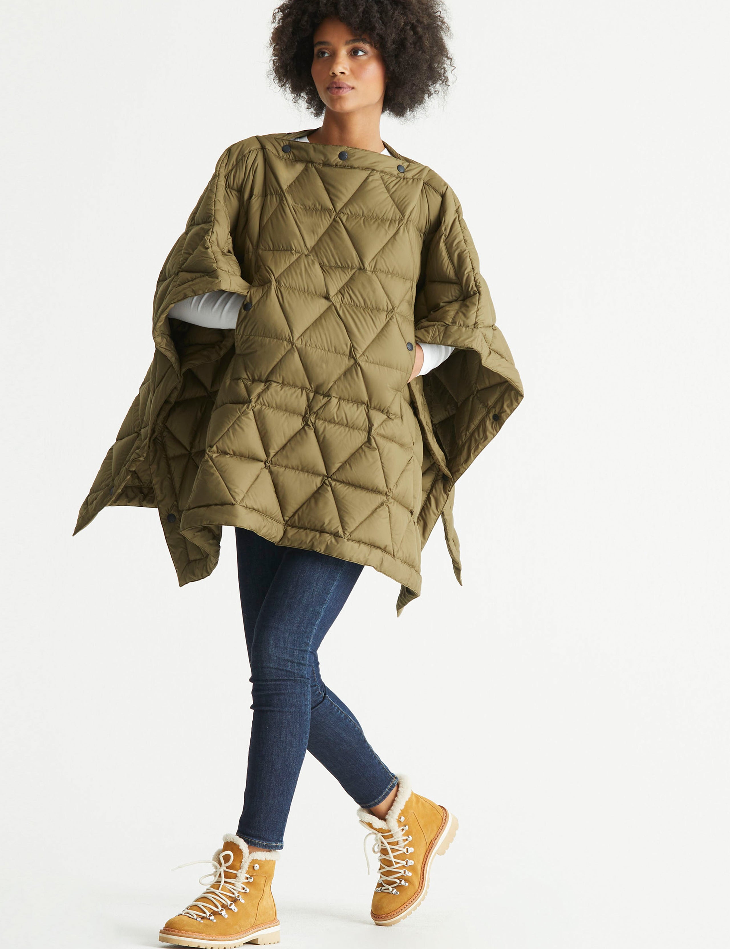 Front 3/4 full-body view of woman wearing Down Poncho in Command Green from AETHER Apparel.