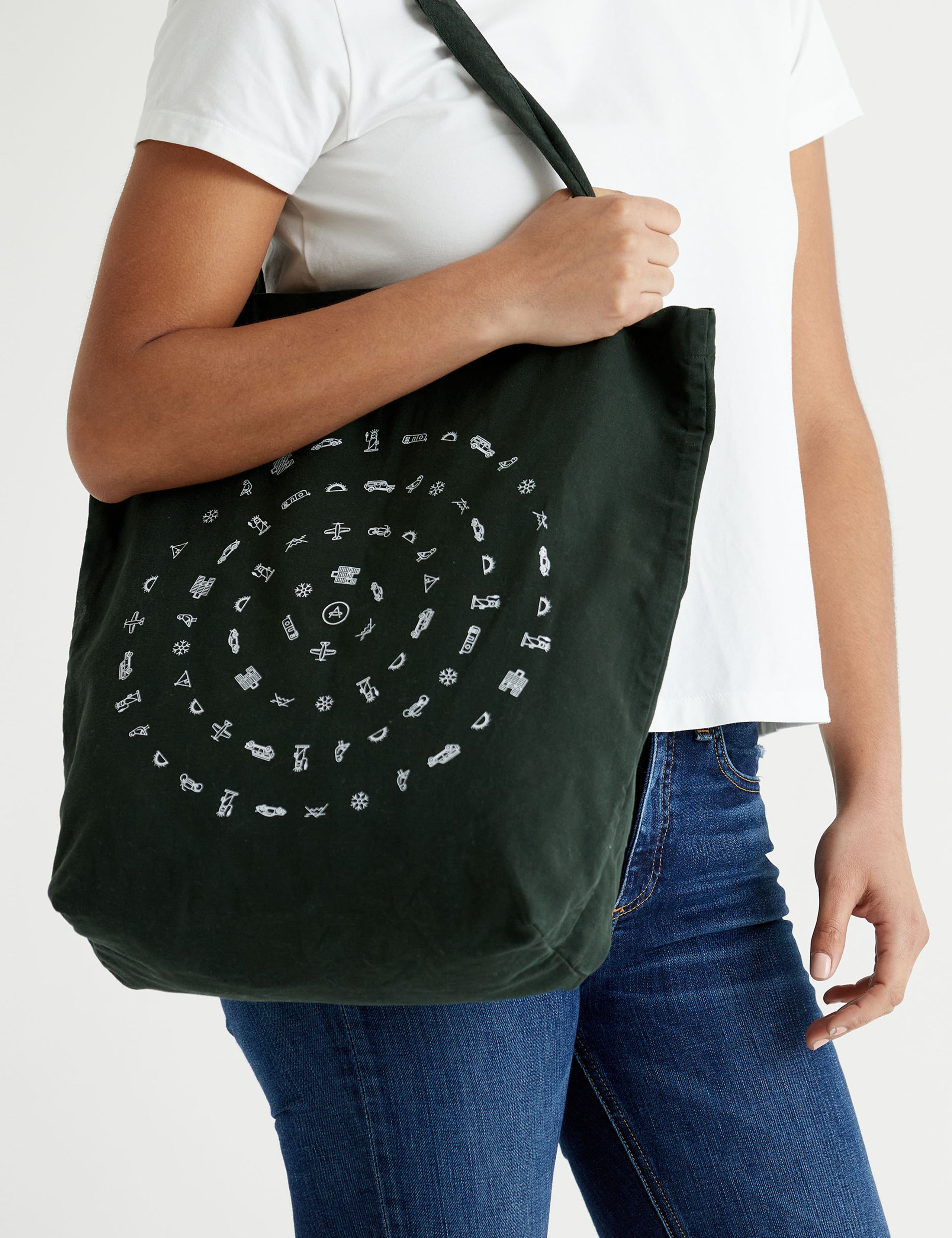 Front angled view of woman carrying Lifestyle Canvas Tote in Duffle Green from AETHER Apparel over shoulder.