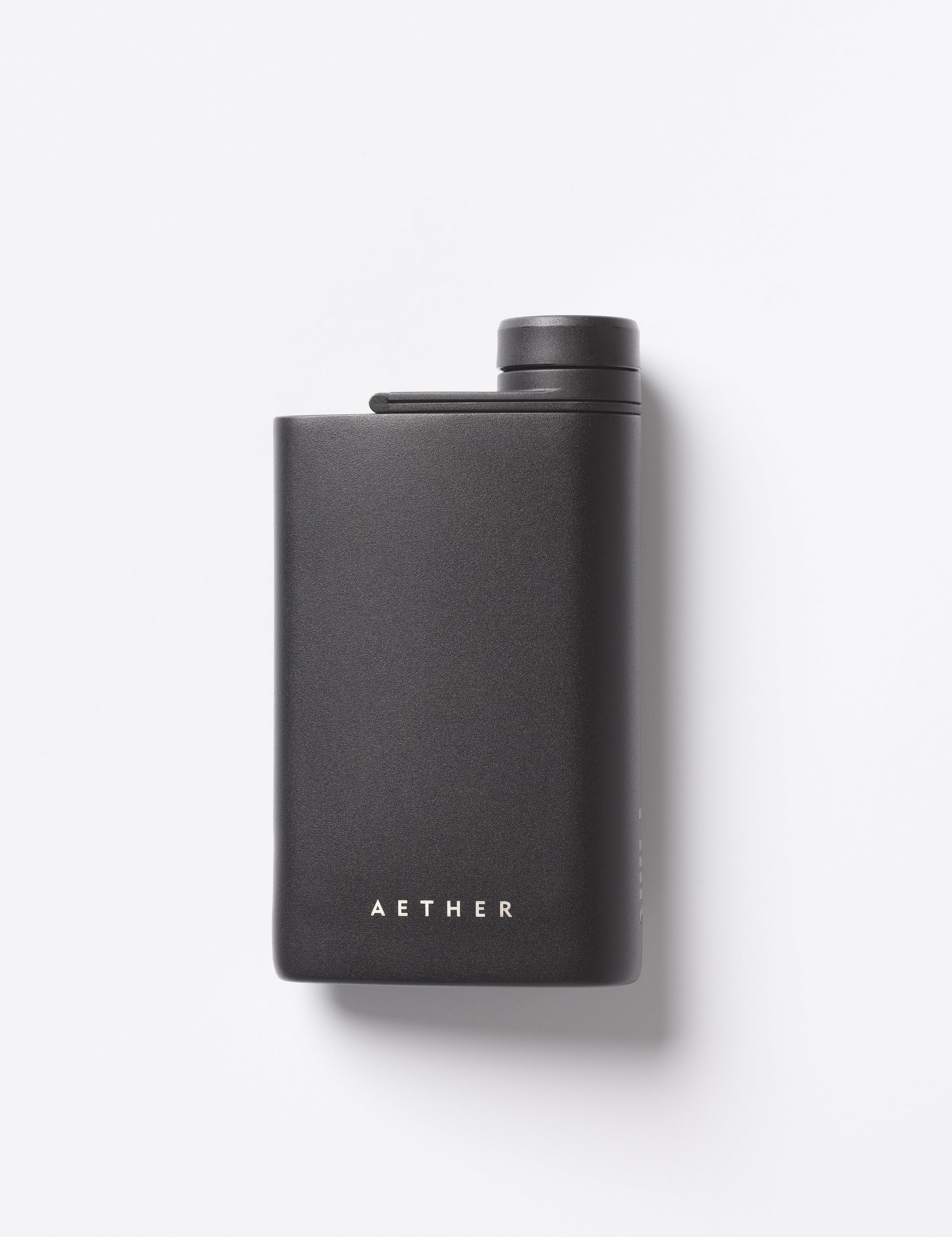Flat lay view of rear side of AETHER + Miir Aero Flask in Black with top open.