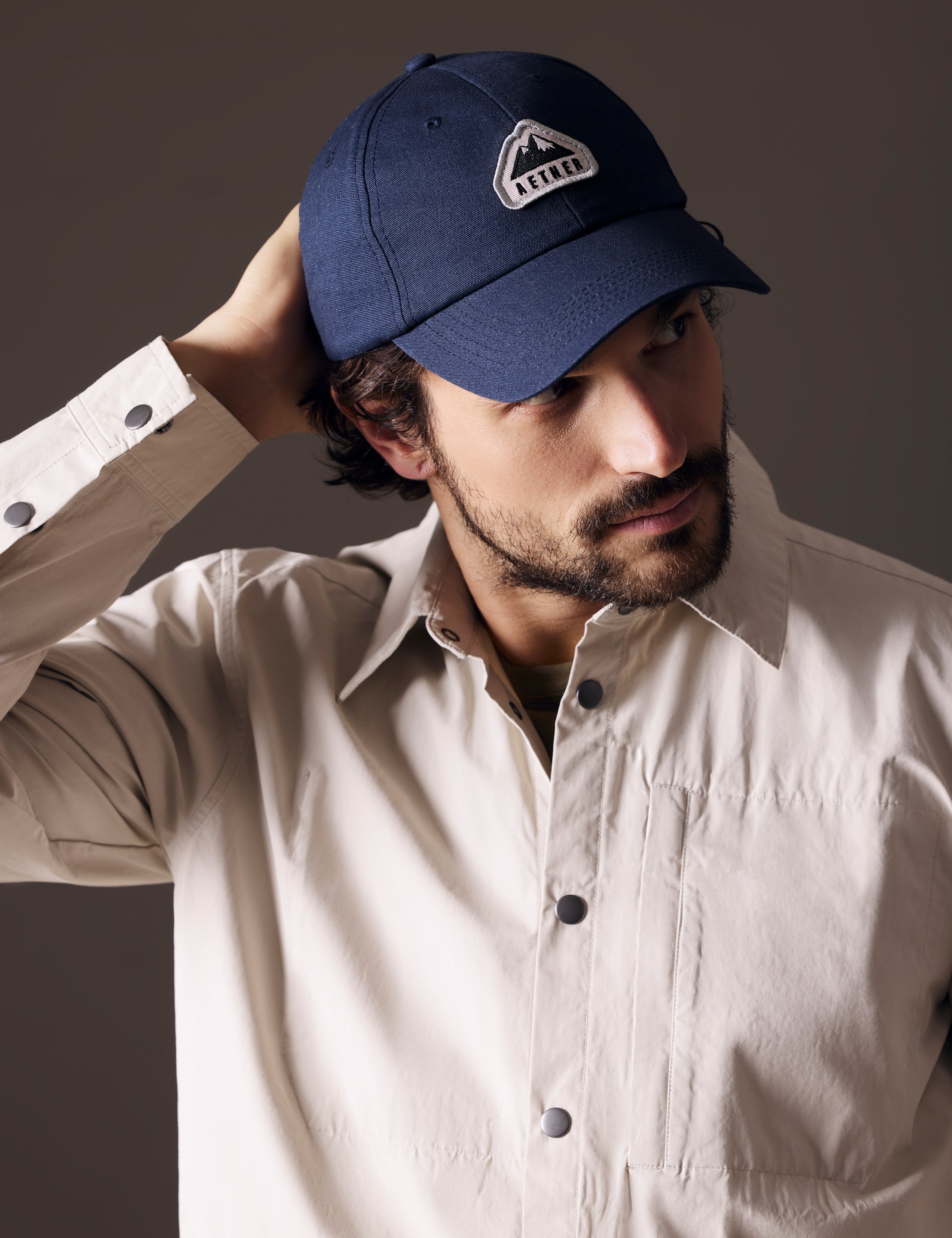 Front angled view of man wearing AETHER Mountain Hat in Nordic Navy blue from AETHER Apparel.