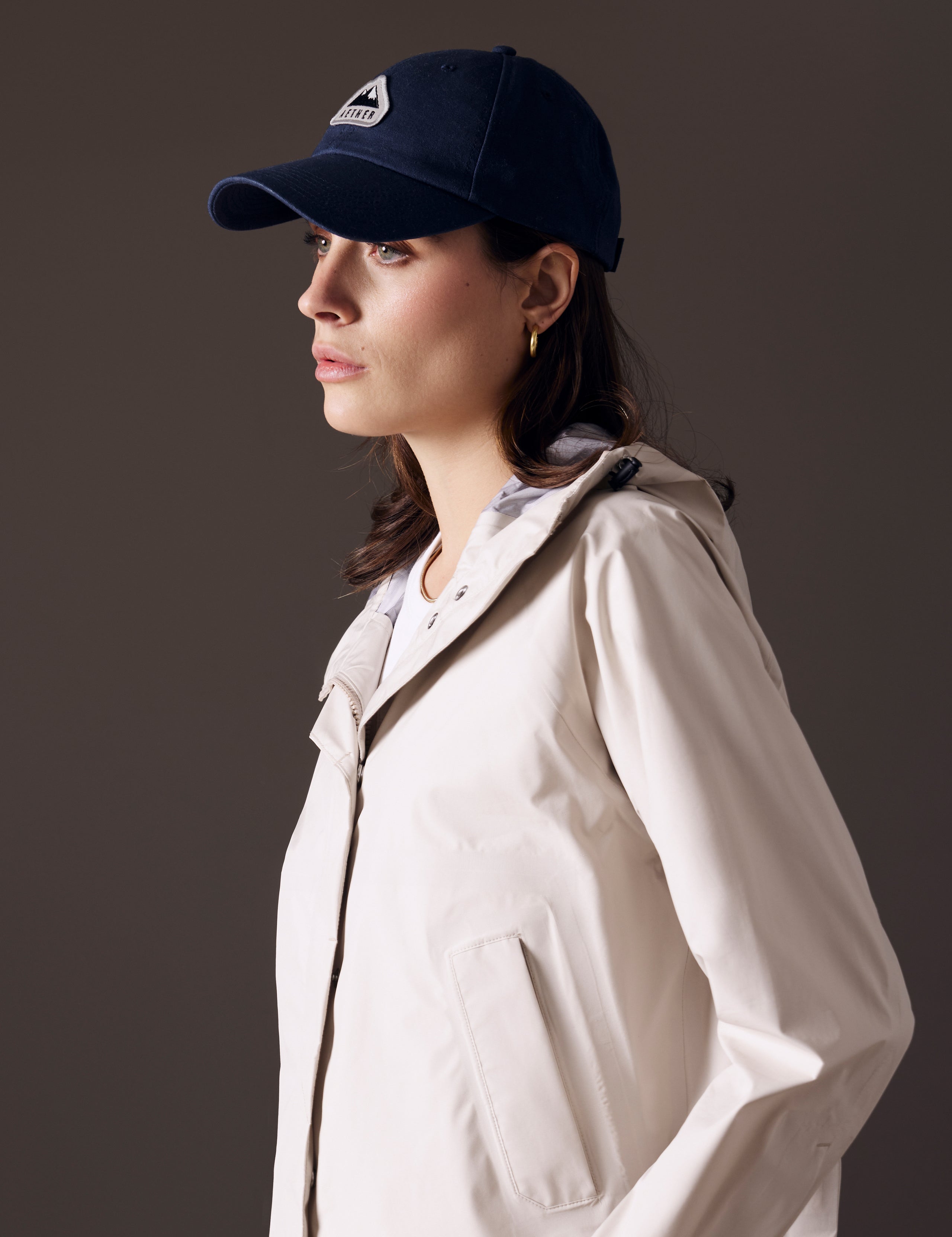 Front angled view of woman wearing AETHER Mountain Hat in Nordic Navy blue from AETHER Apparel.