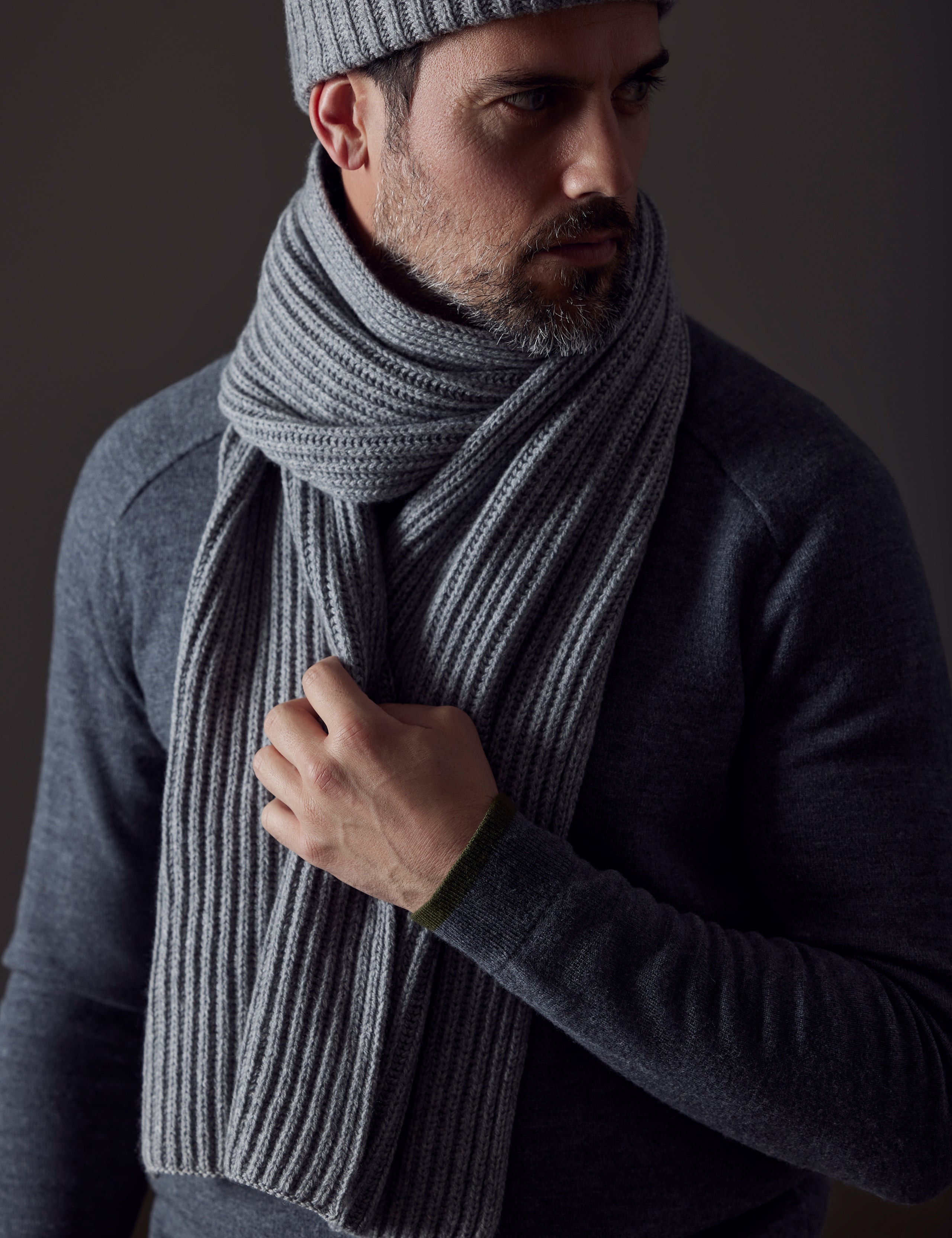 Front view of man wearing Ribbed Cashmere Scarf in Heather Grey from AETHER Apparel. 