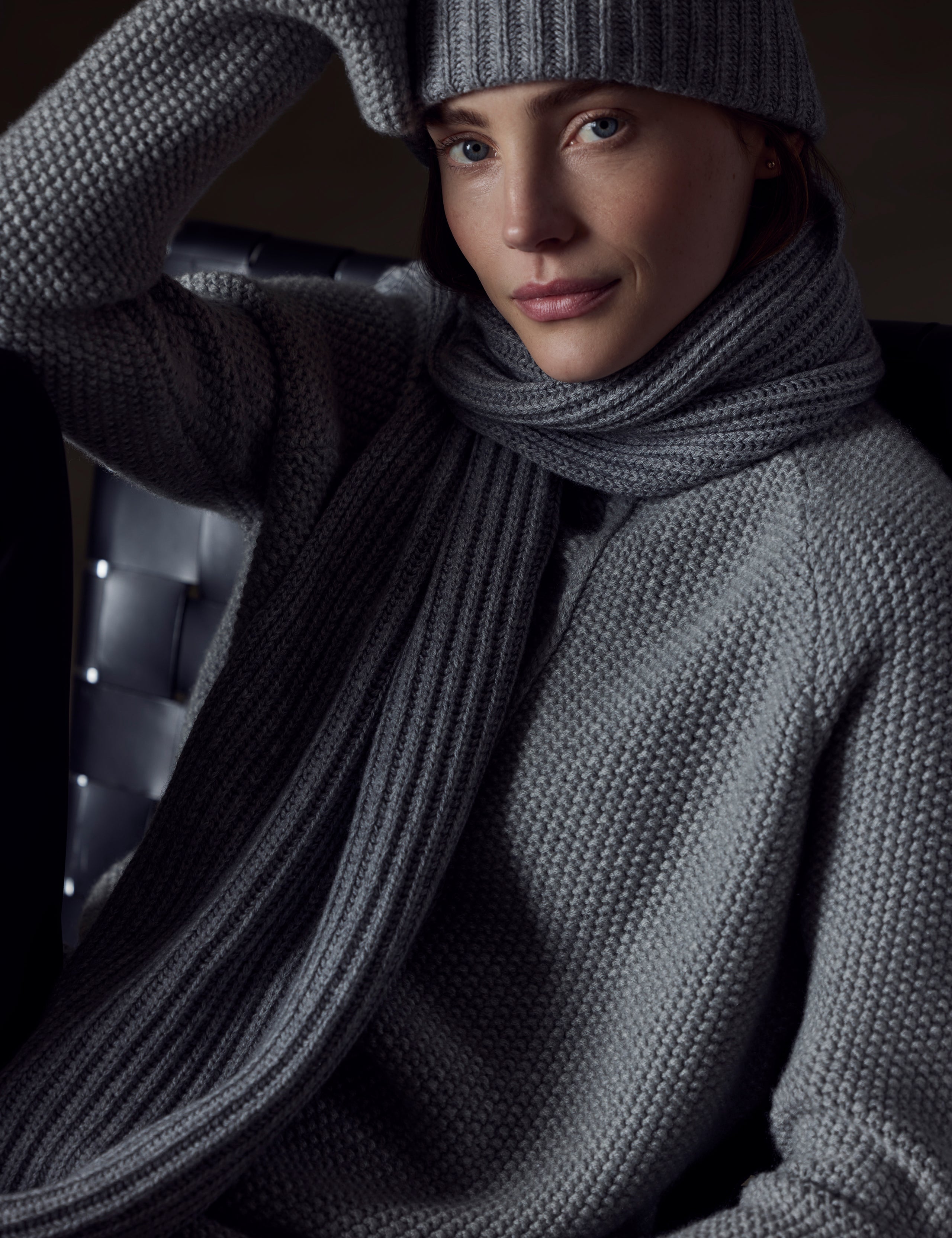 Front view of woman wearing beanie and Ribbed Cashmere Scarf in Heather Grey from AETHER Apparel. 
