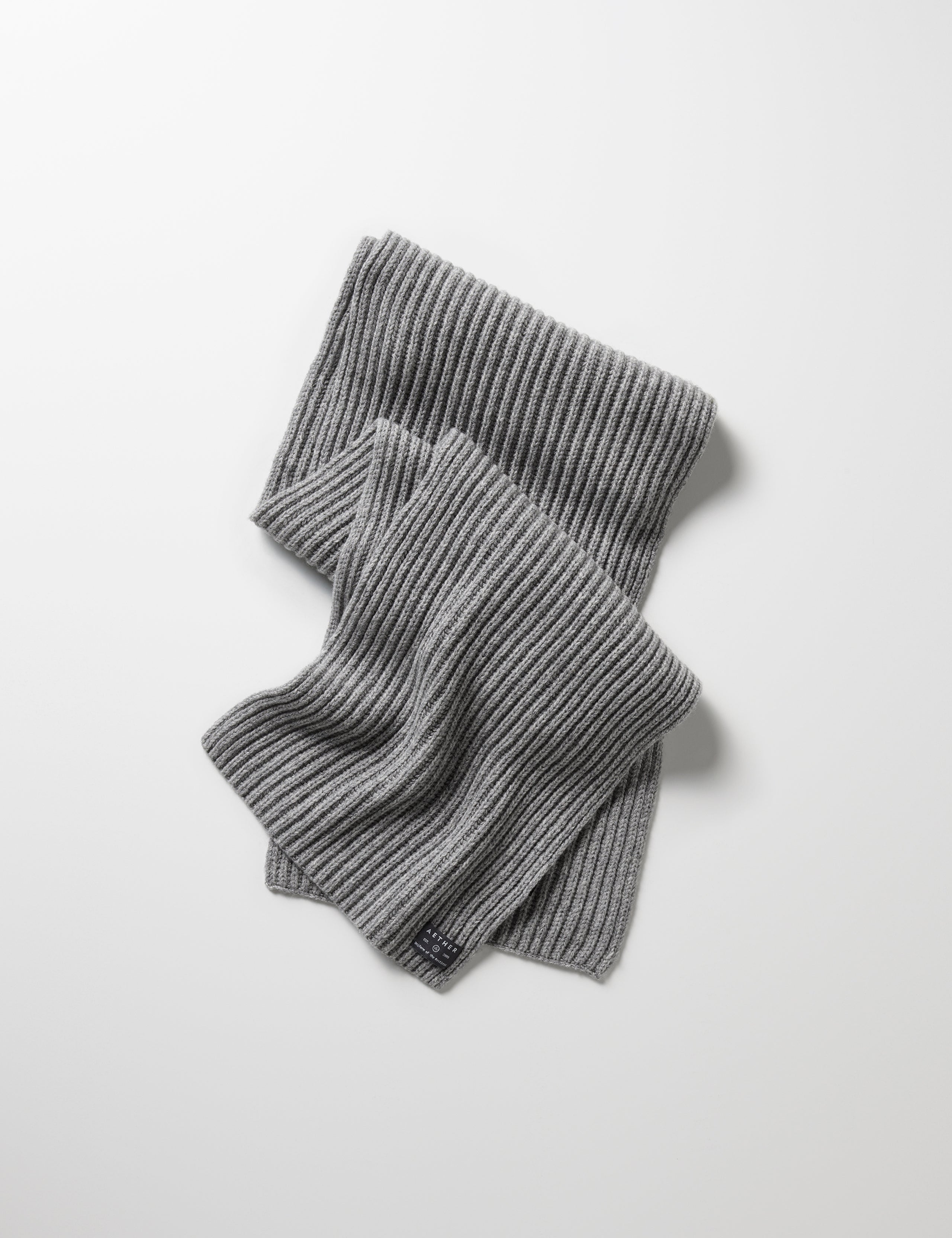 Flat lay of Ribbed Cashmere Scarf in Heather Grey from AETHER Apparel. 