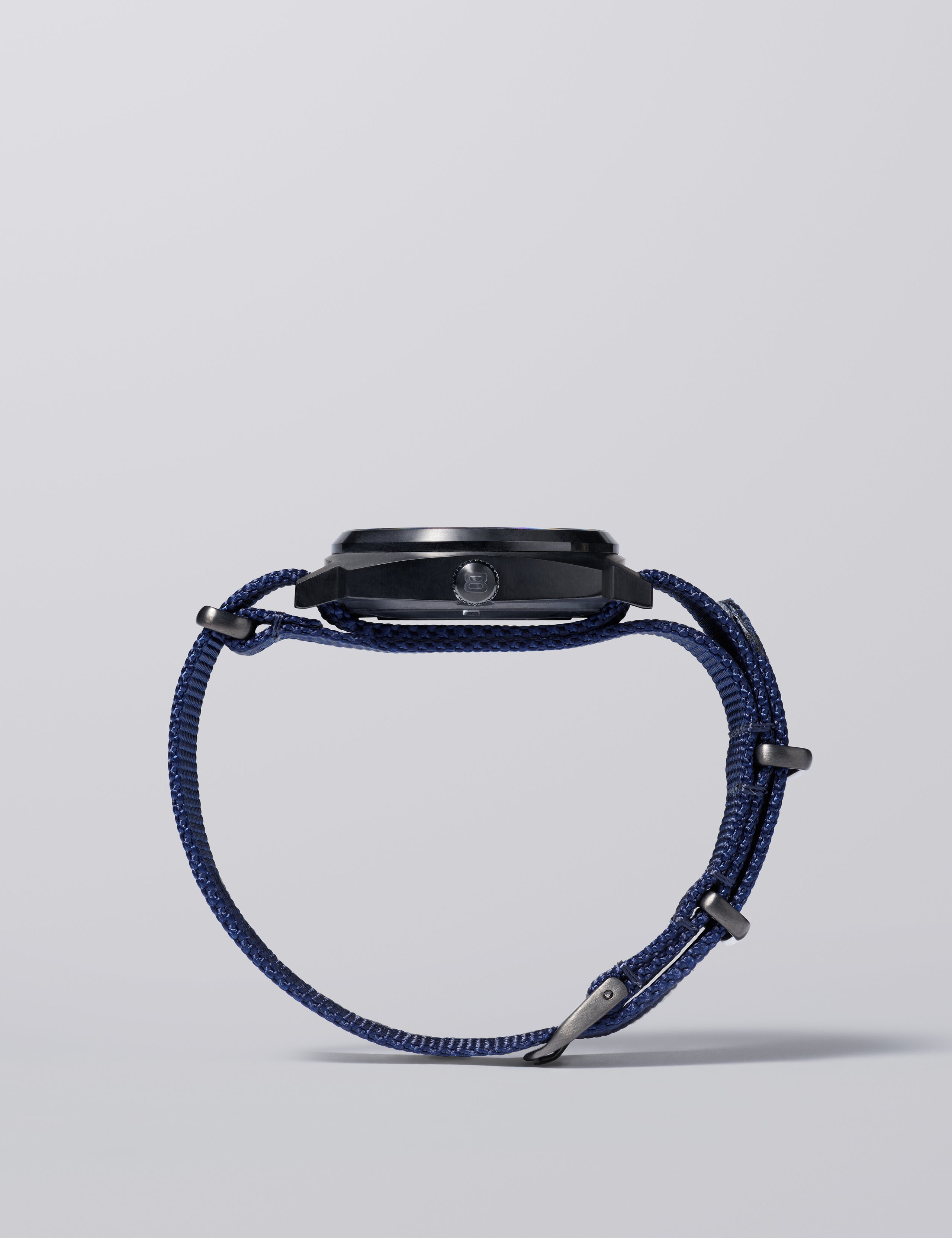 Side view of AETHER and Bamford watch with blue NATO strap.