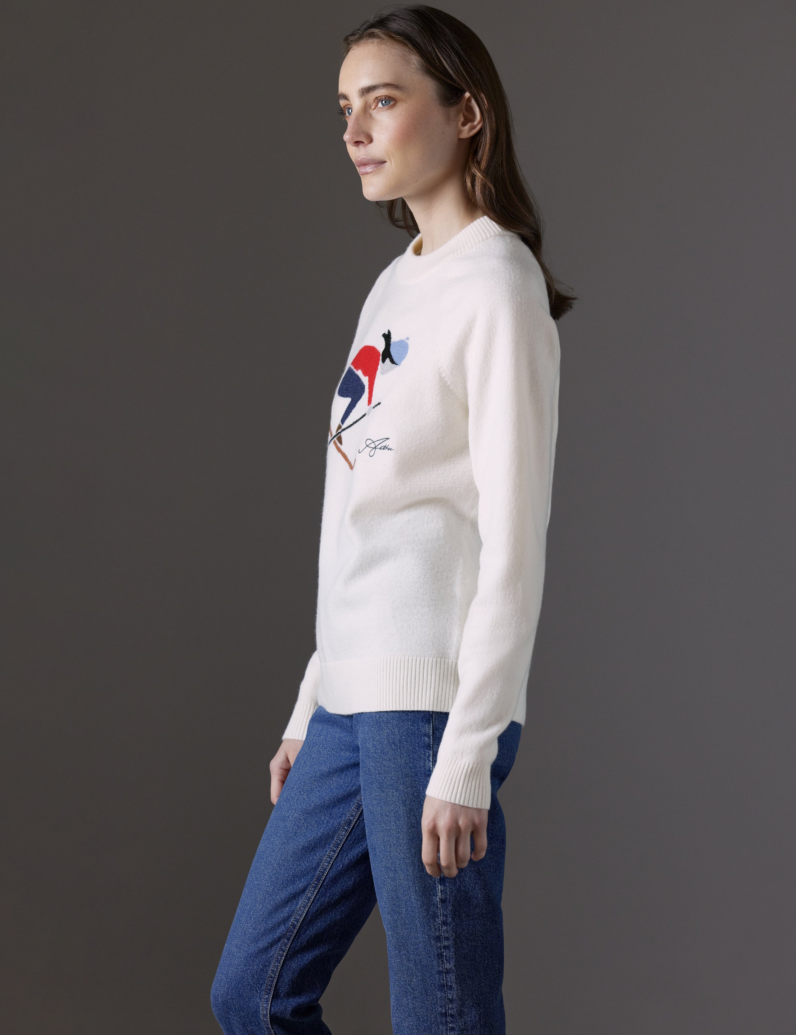 Side profile view of woman wearing Bridget Sweater in Winter White from AETHER Apparel.