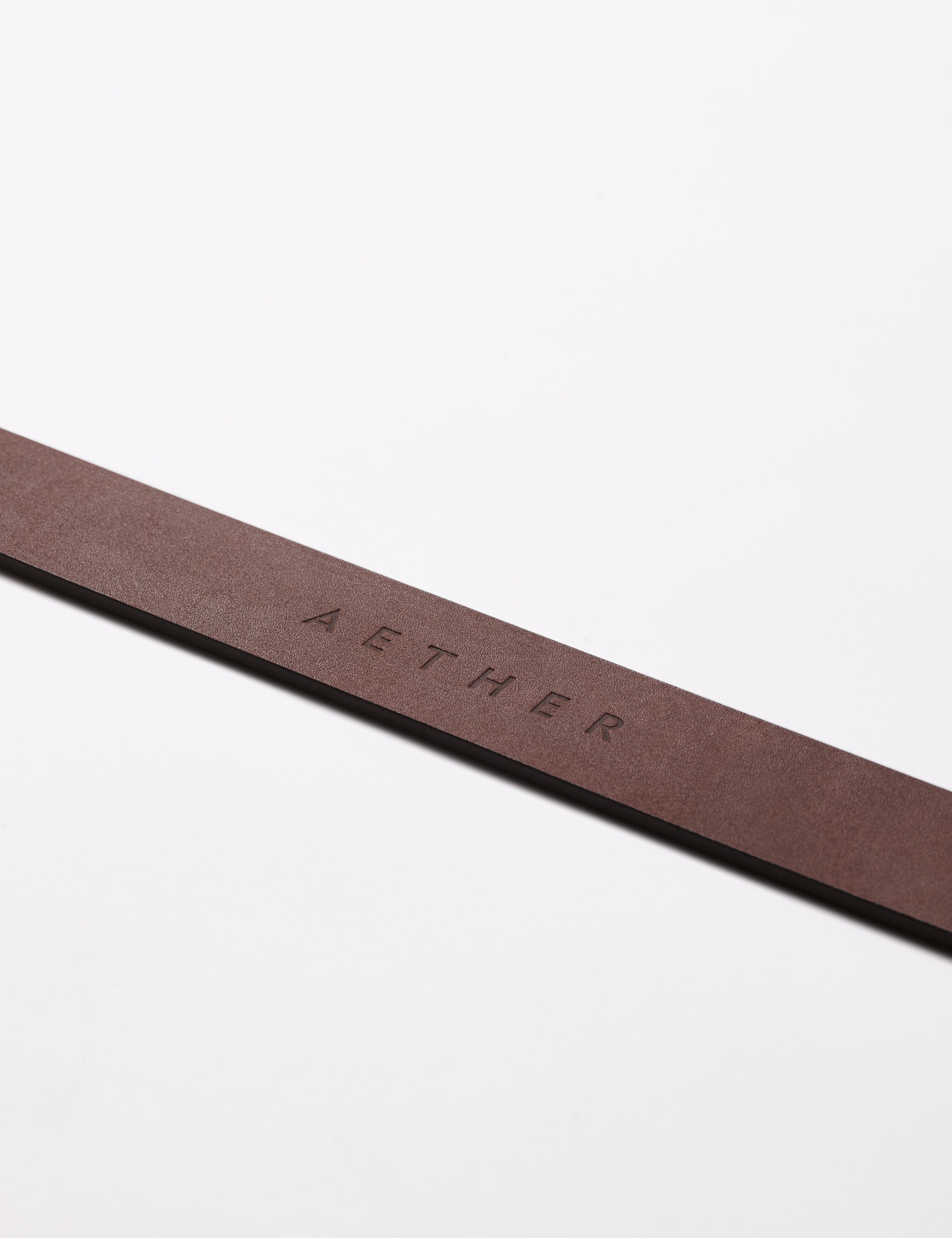 AETHER logo on strap of brown Canyon Leather Belt from AETHER Apparel