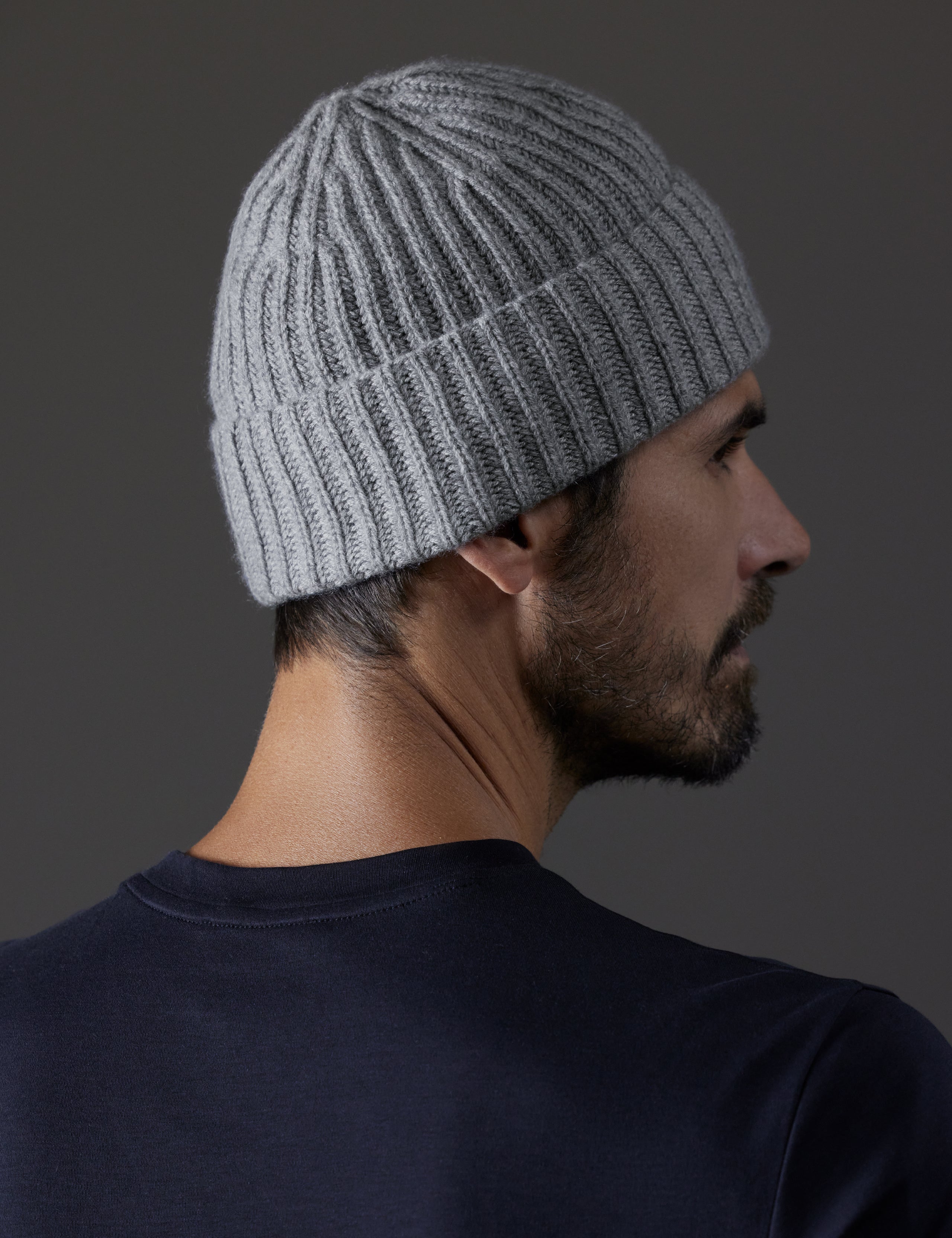 Rear angled view of man wearing Cashmere Hat in Heather Grey from AETHER Apparel. 