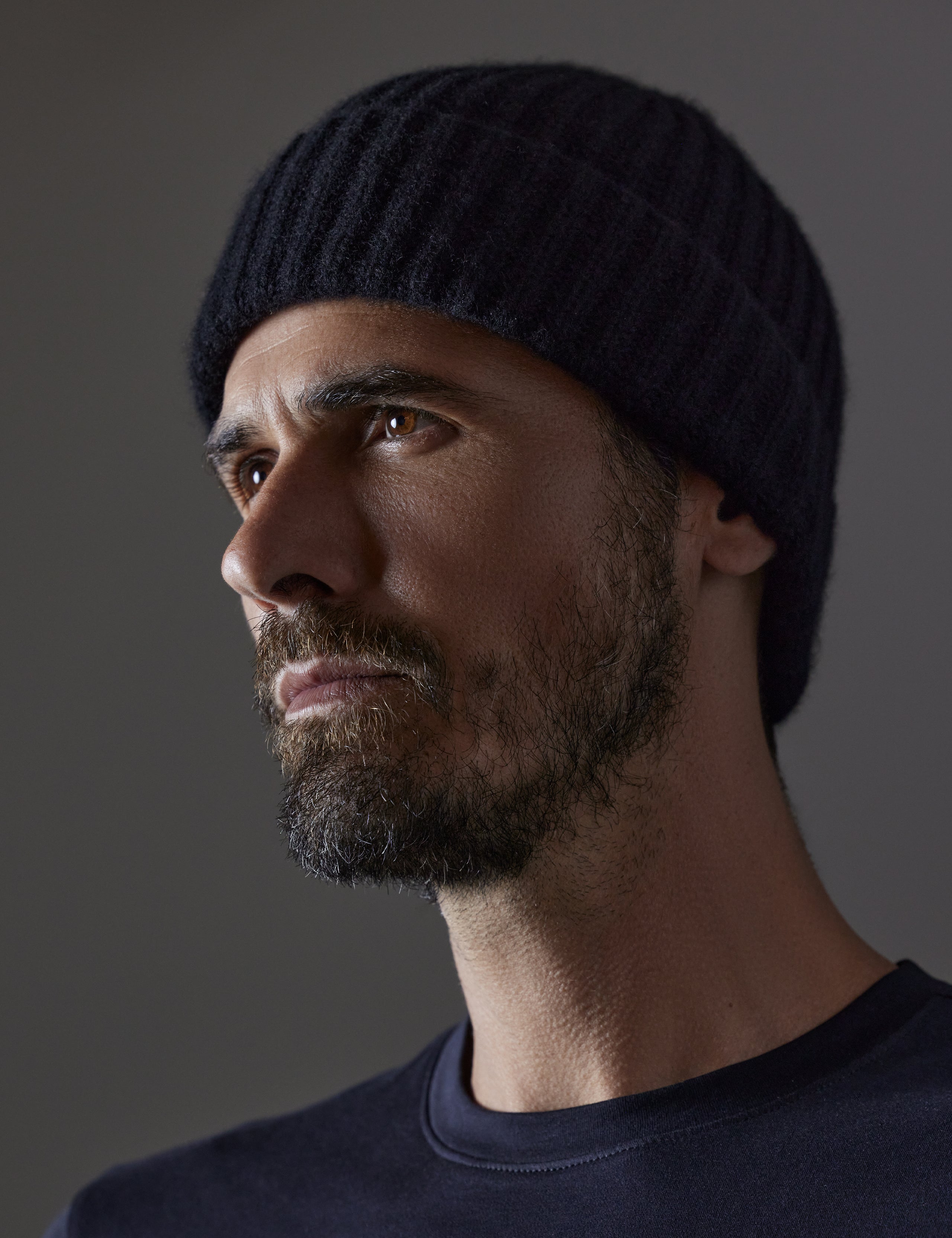 Front angled view of man wearing Cashmere Hat in Onyx Black from AETHER Apparel. 