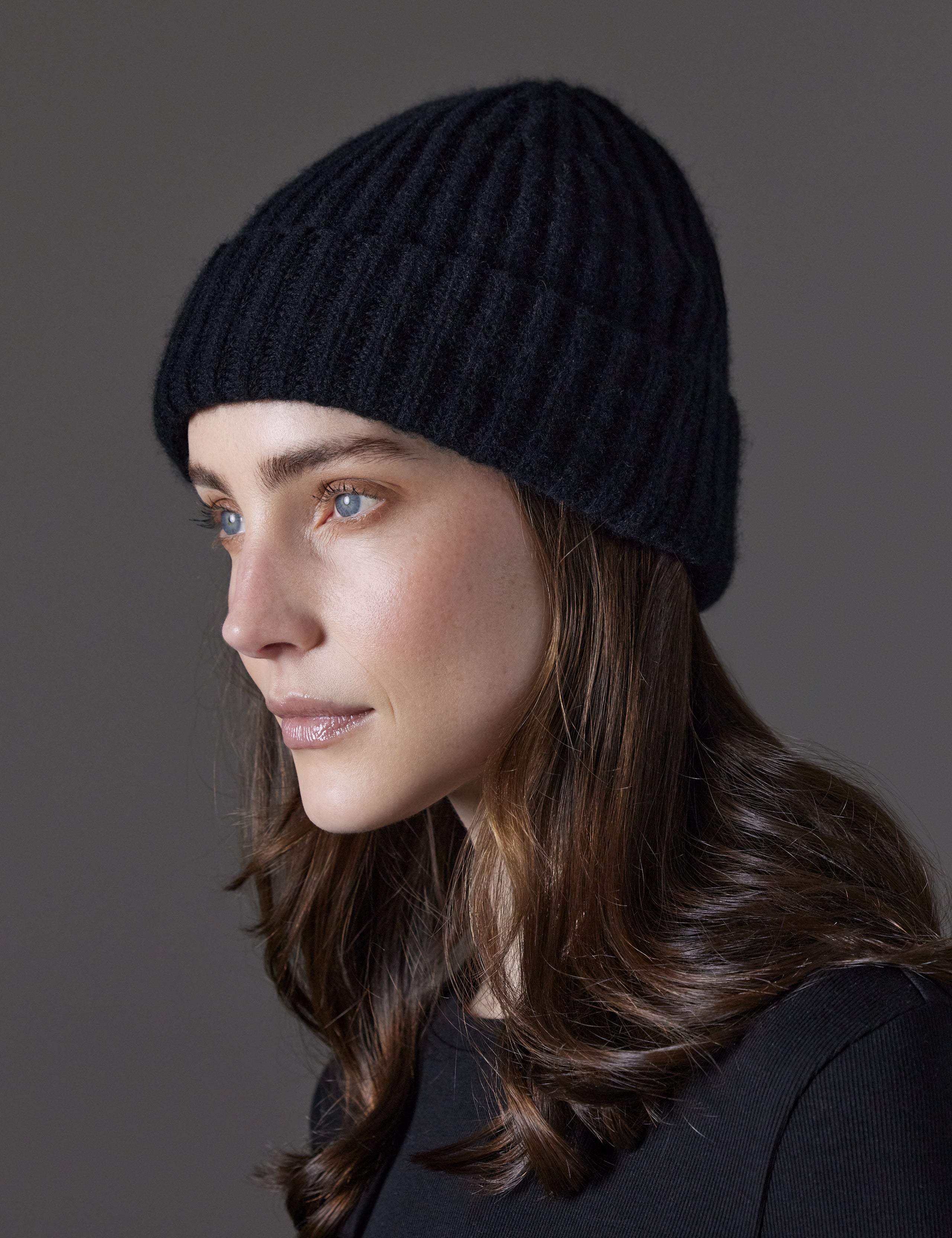 Front angled view of woman wearing Cashmere Hat in Onyx Black from AETHER Apparel. 