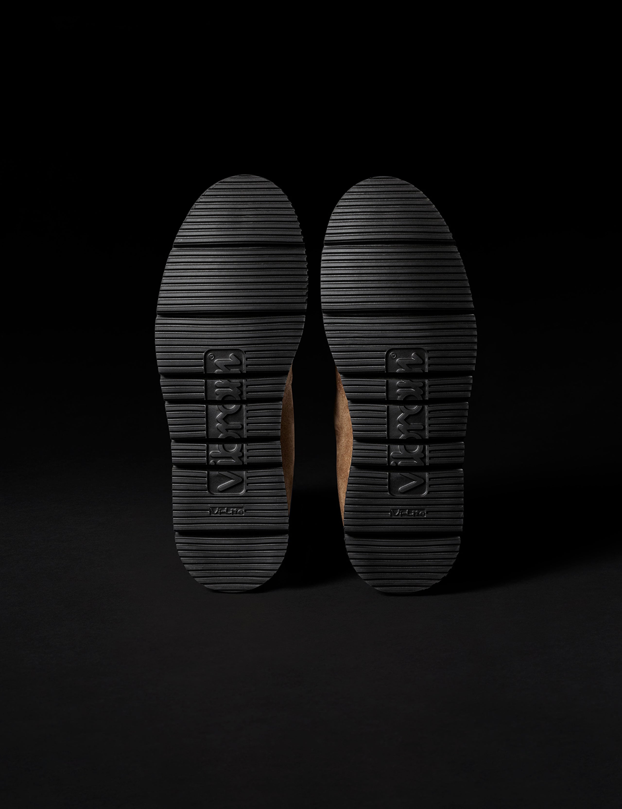 Bottom view of Vibram Vi-Lite outsoles on AETHER Chelsea Boot in Taupe from AETHER Apparel.