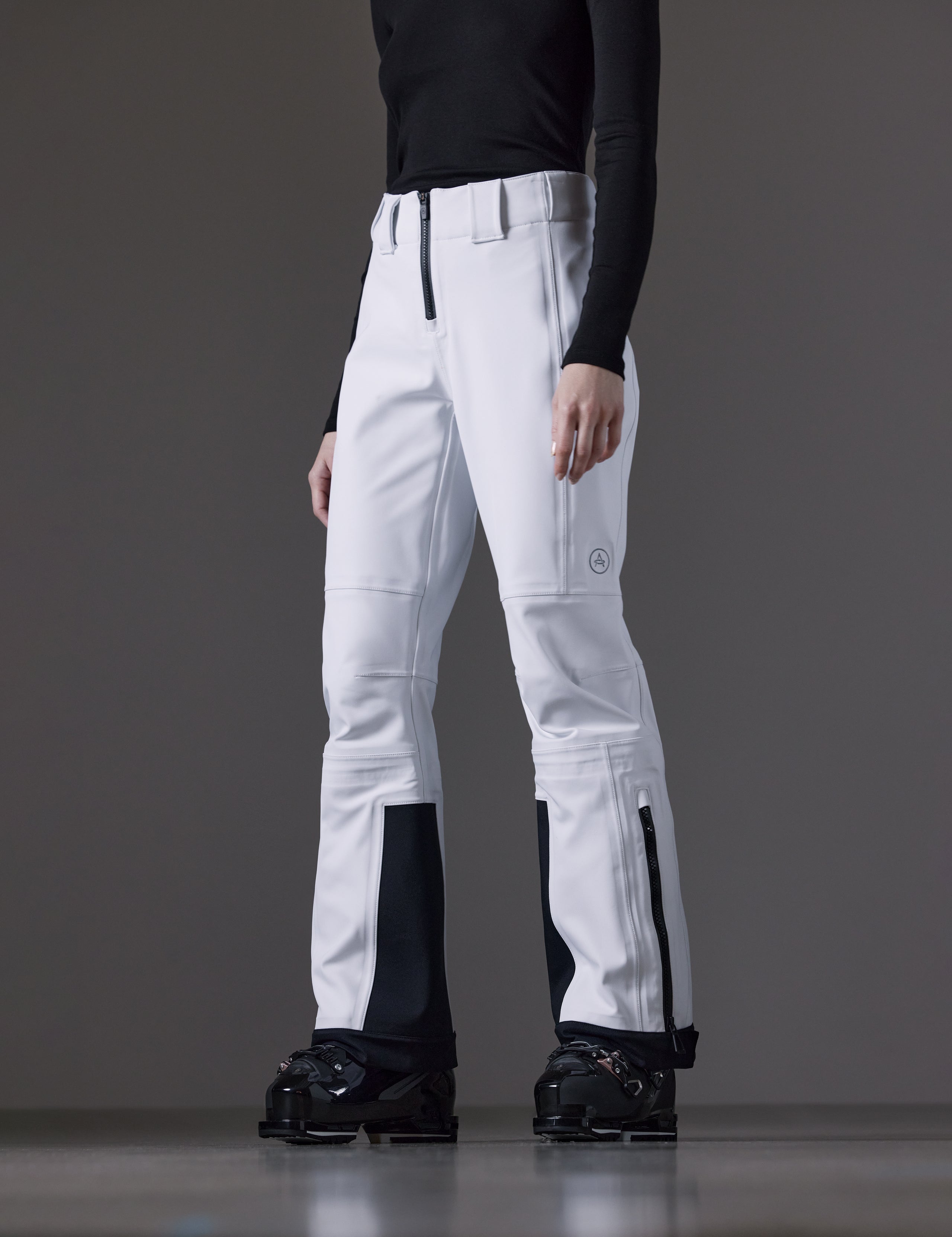 Front angled lower body view of woman wearing Descent Pant in White from AETHER Apparel.