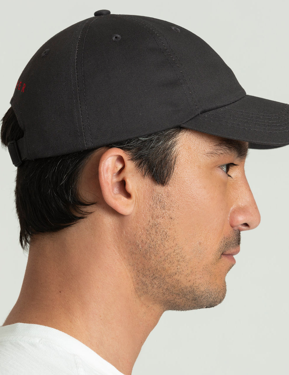 Side profile view of man wearing Everyday Hat in Graphite from AETHER Apparel.