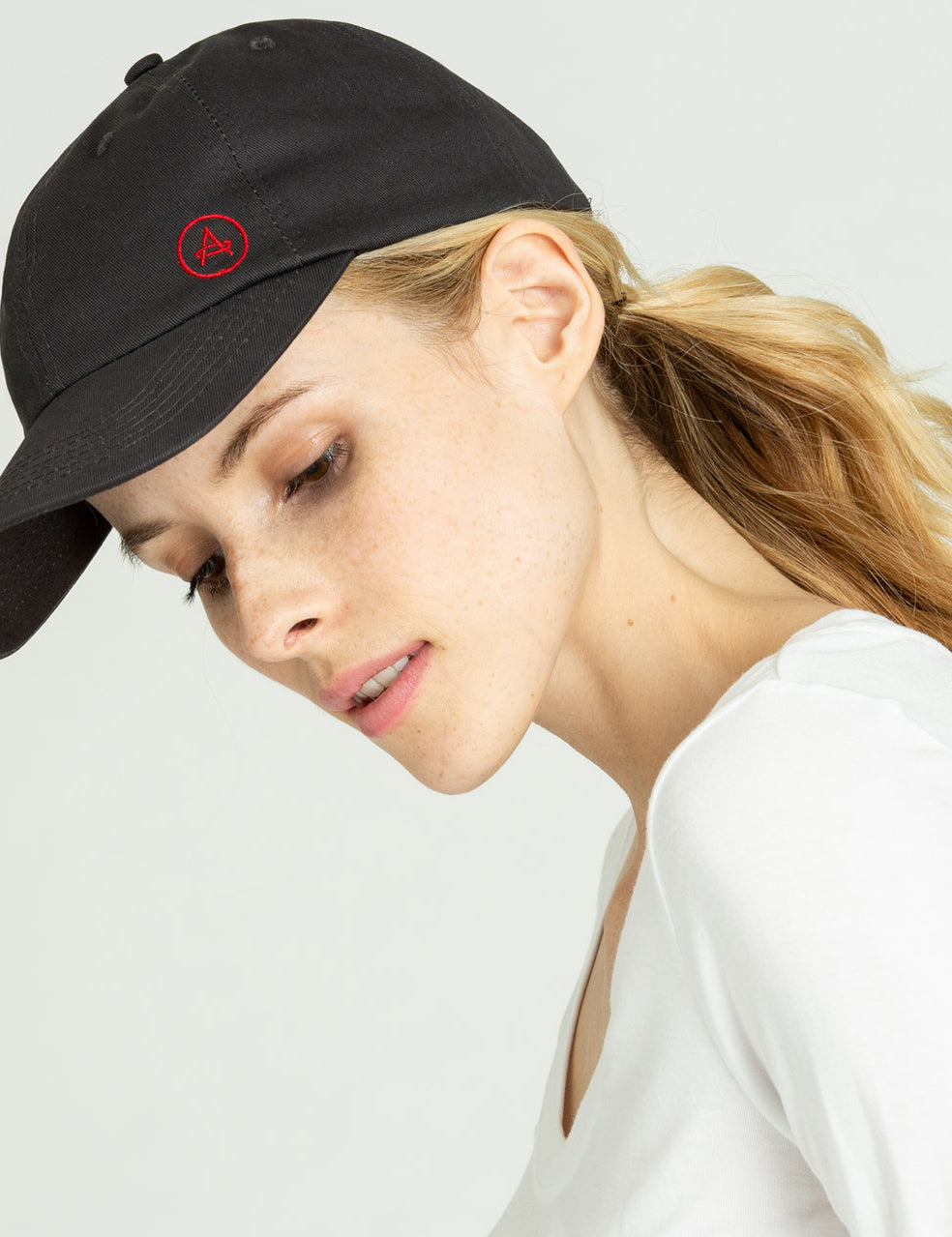 Front angled view of woman wearing Everyday Hat in Graphite from AETHER Apparel.