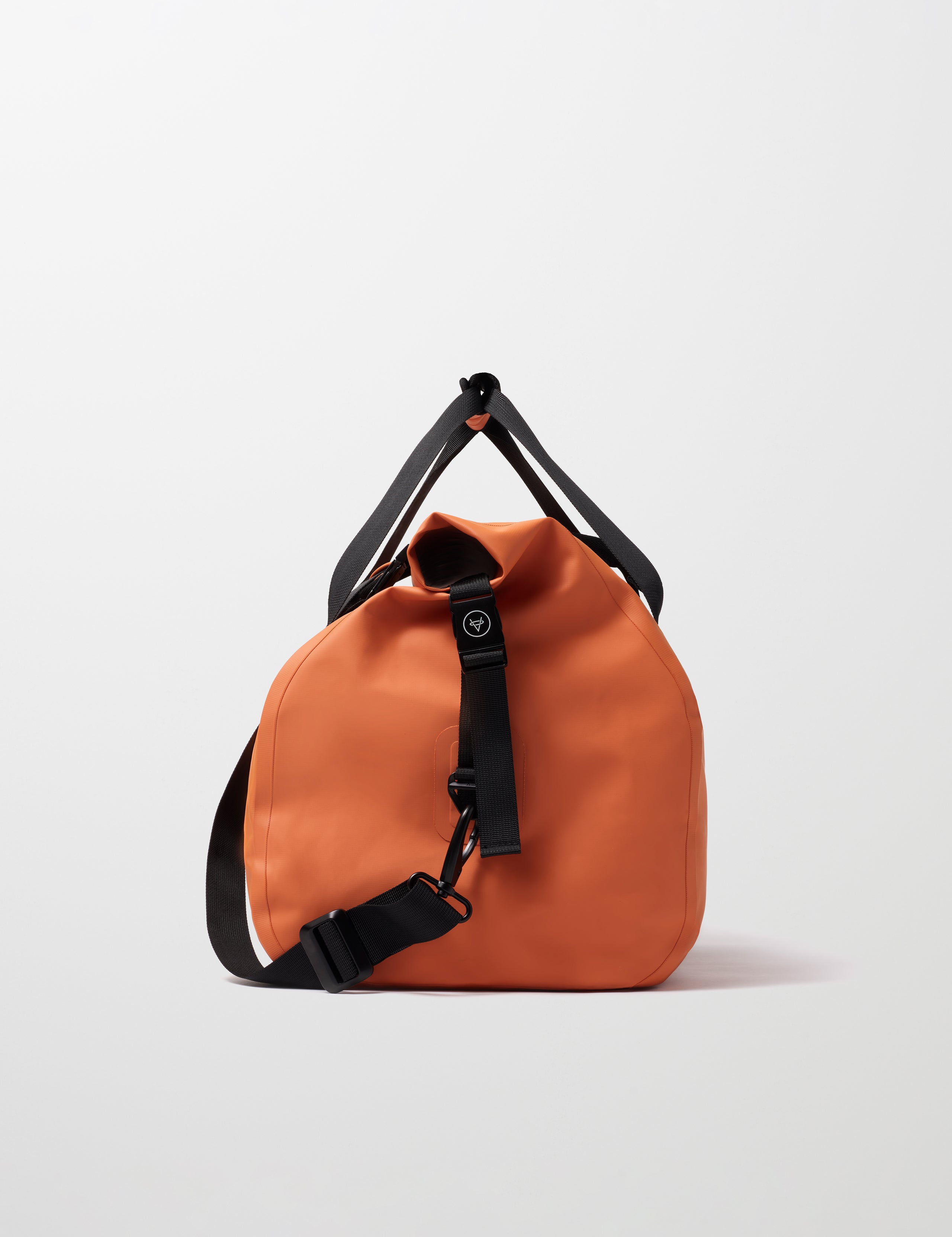 Side profile view of Excursion Duffle Bag 45L in Autumn Orange from AETHER Apparel.