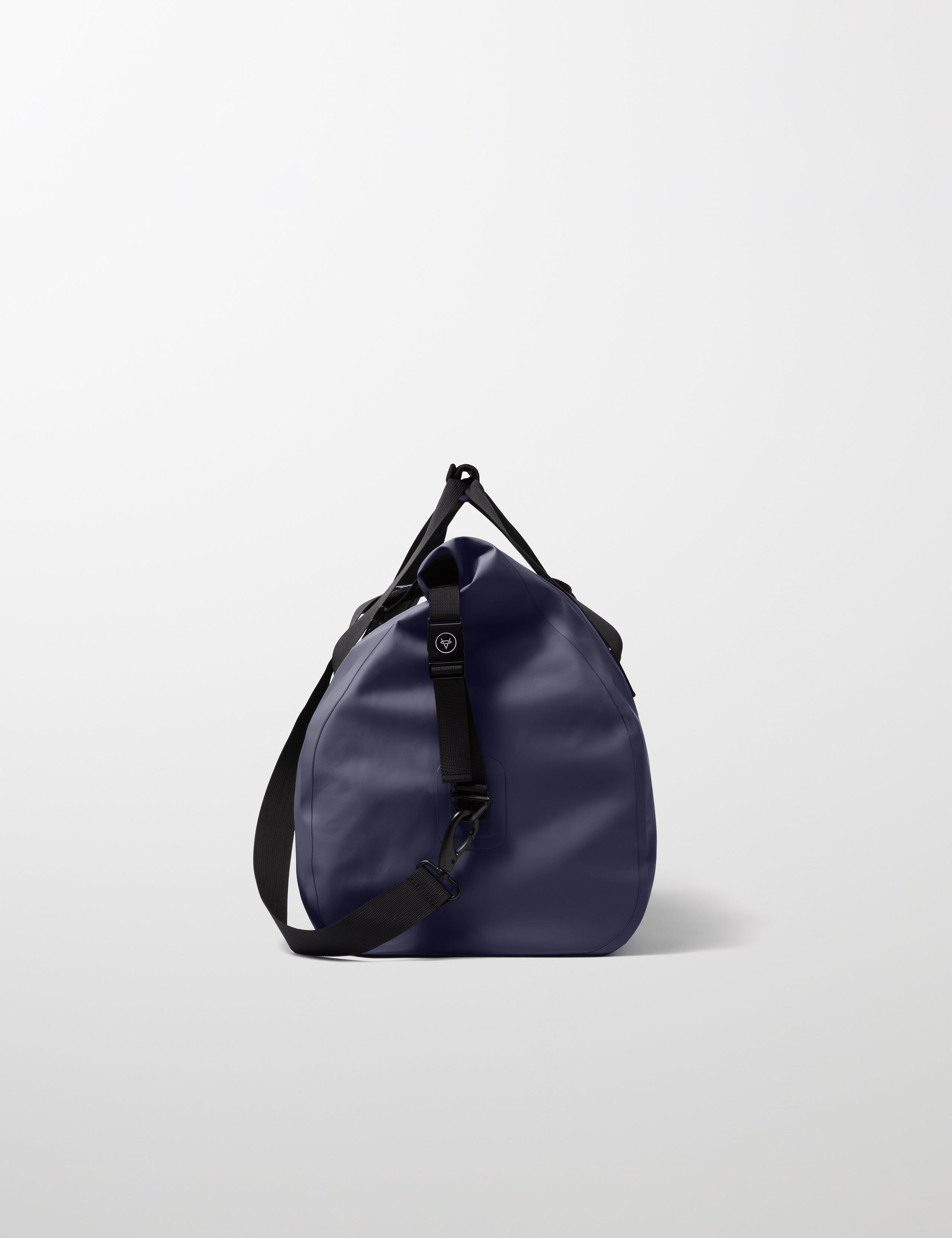 Side profile view of Excursion Duffle Bag 60L in Total Eclipse dark blue from AETHER Apparel.