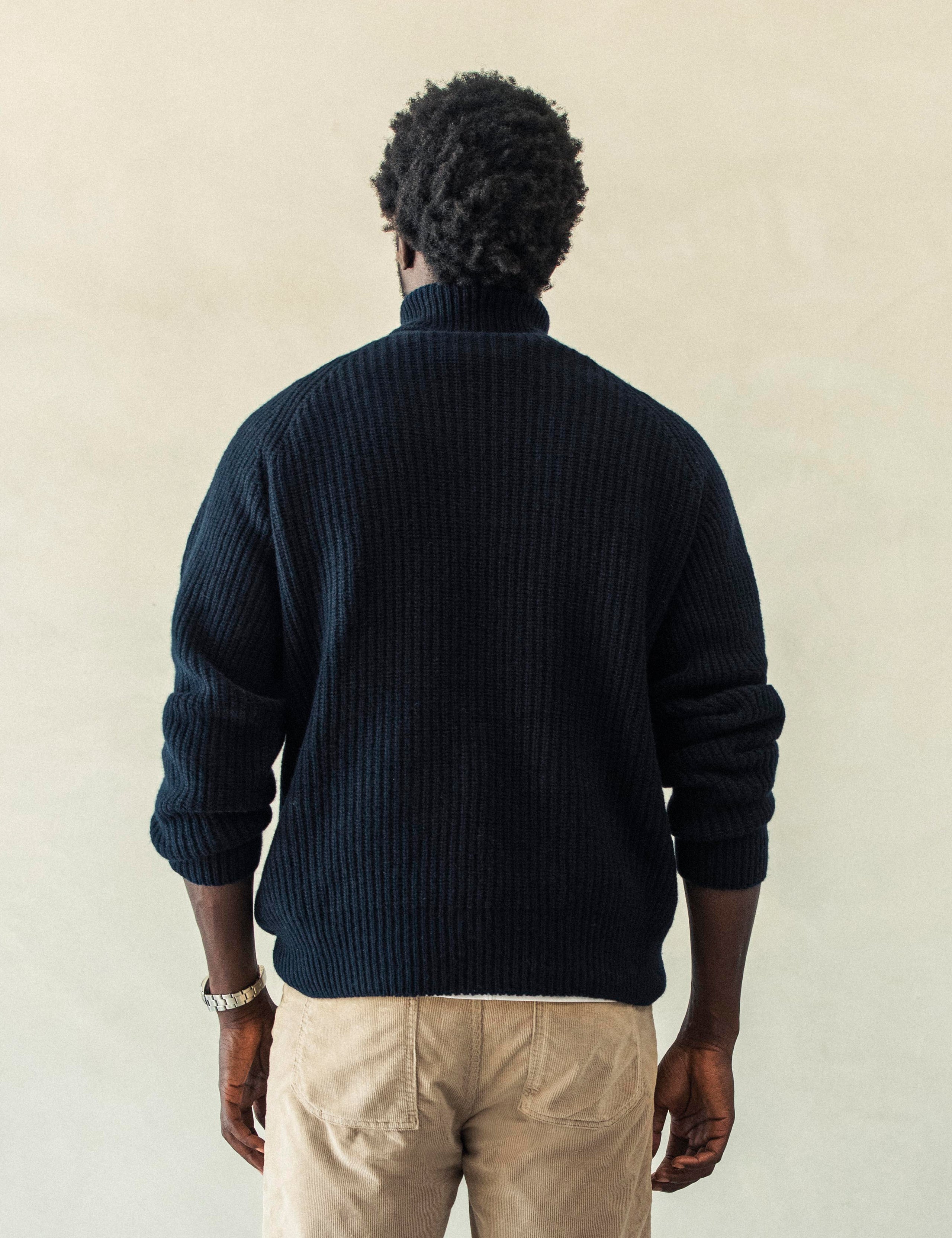 Rear view of man wearing Finley Sweater in Total Eclipse dark blue from AETHER Apparel.
