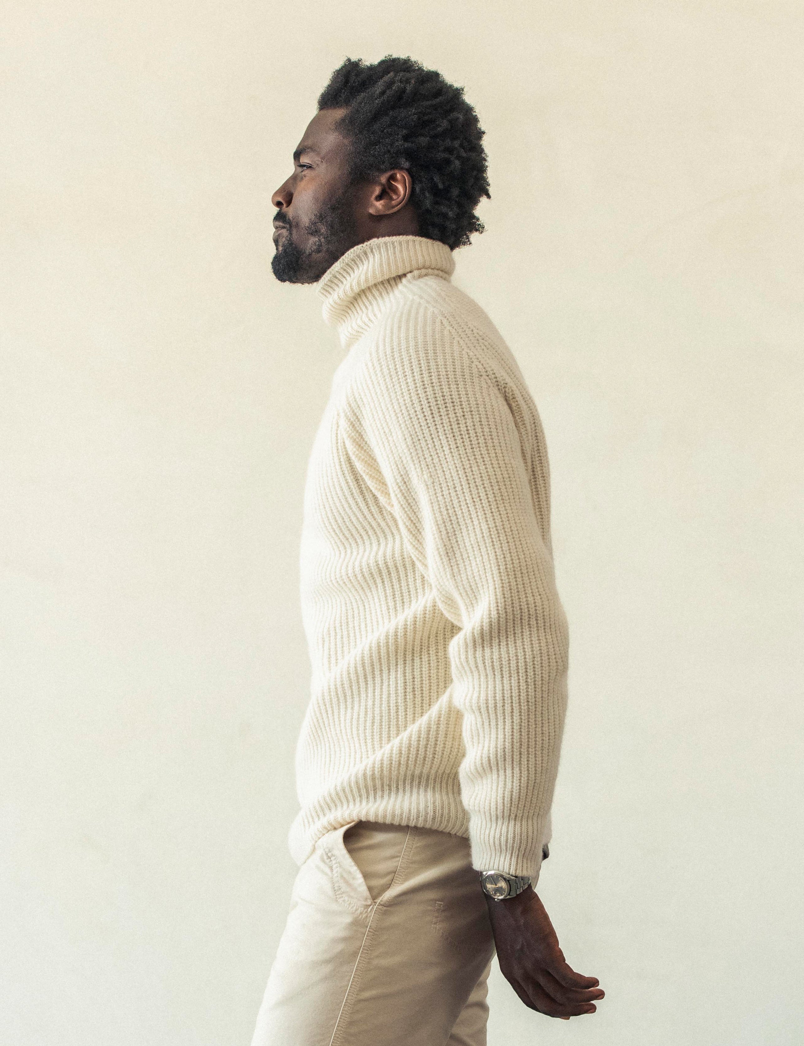 Left side profile view of man wearing Finley Sweater in Winter White from AETHER Apparel.