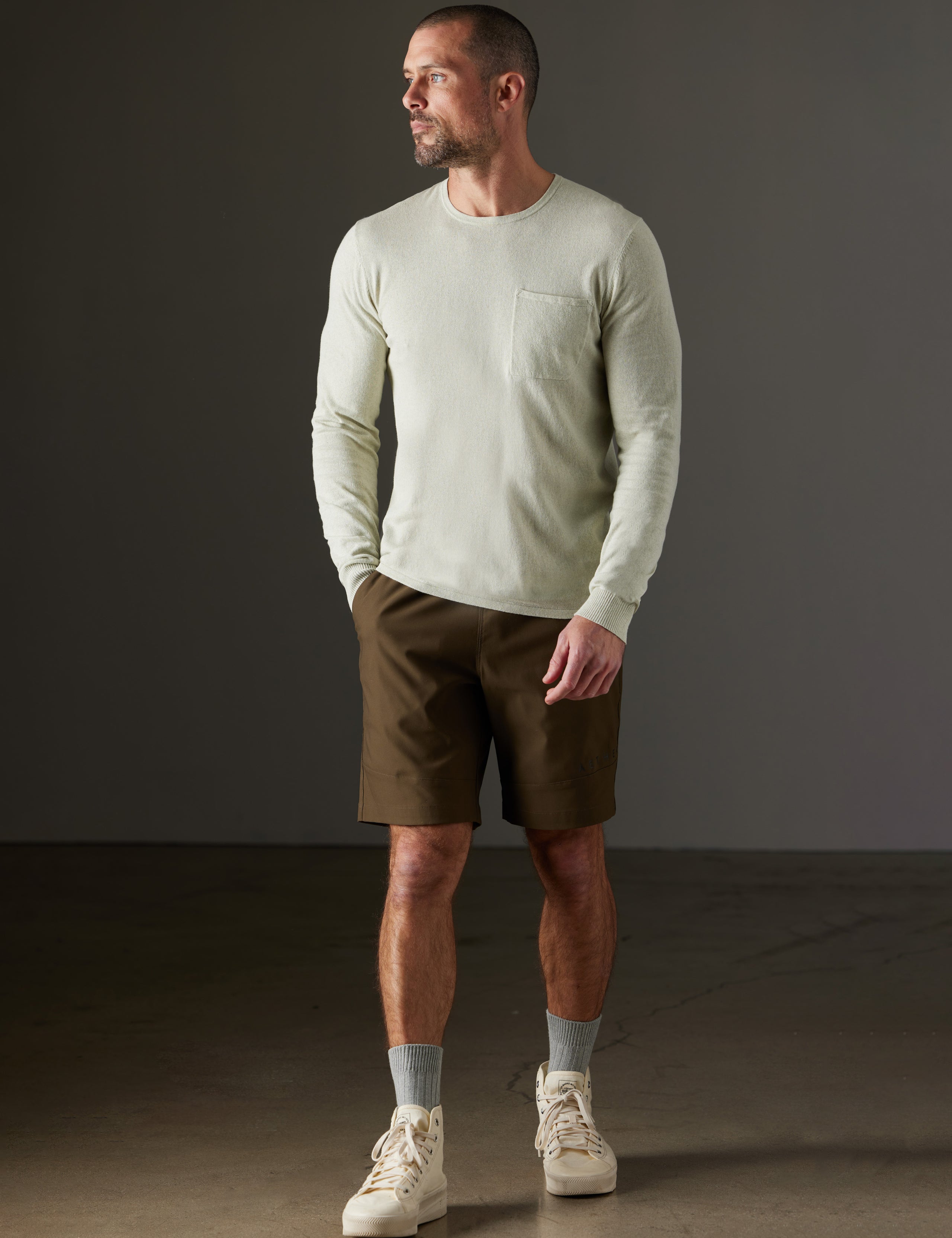 Front full-body view of man wearing Aero Sweater in Light Sage Heather from AETHER Apparel.