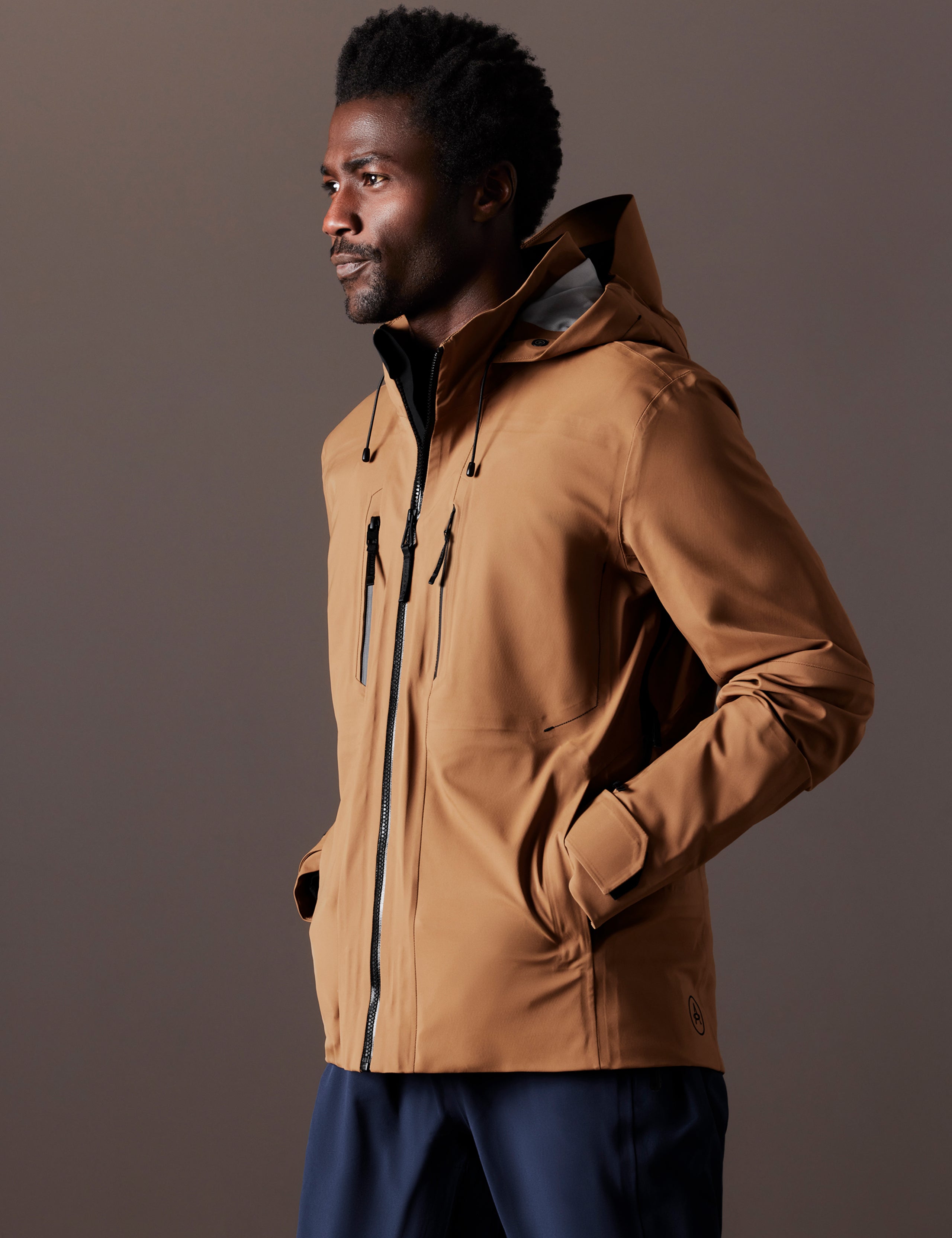 Front 3/4 body view of man wearing Altitude Snow Shell 2.0 in Rubber Brown from AETHER Apparel.