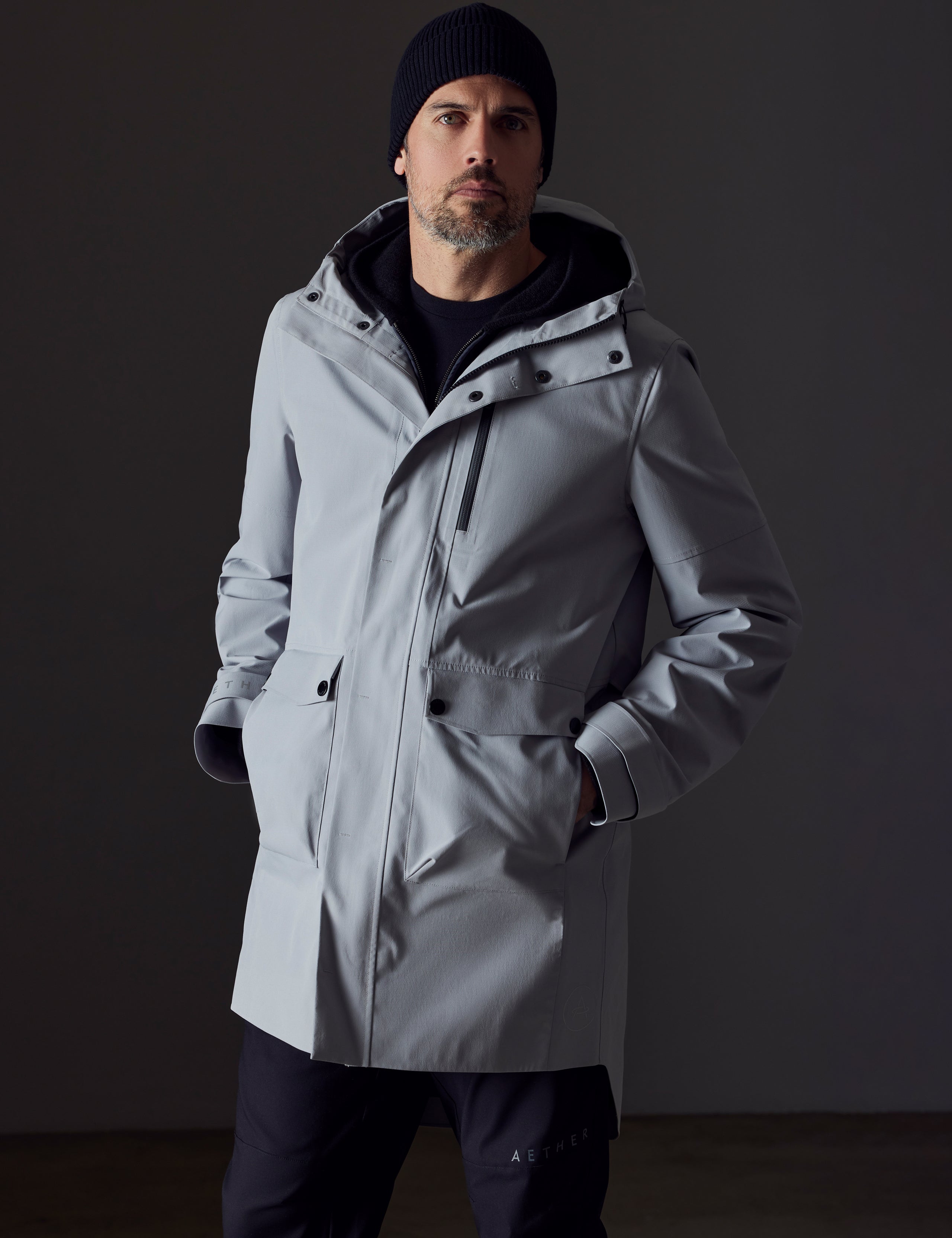 Front body view of man wearing Anders Rain Jacket in Sky Grey from AETHER Apparel.