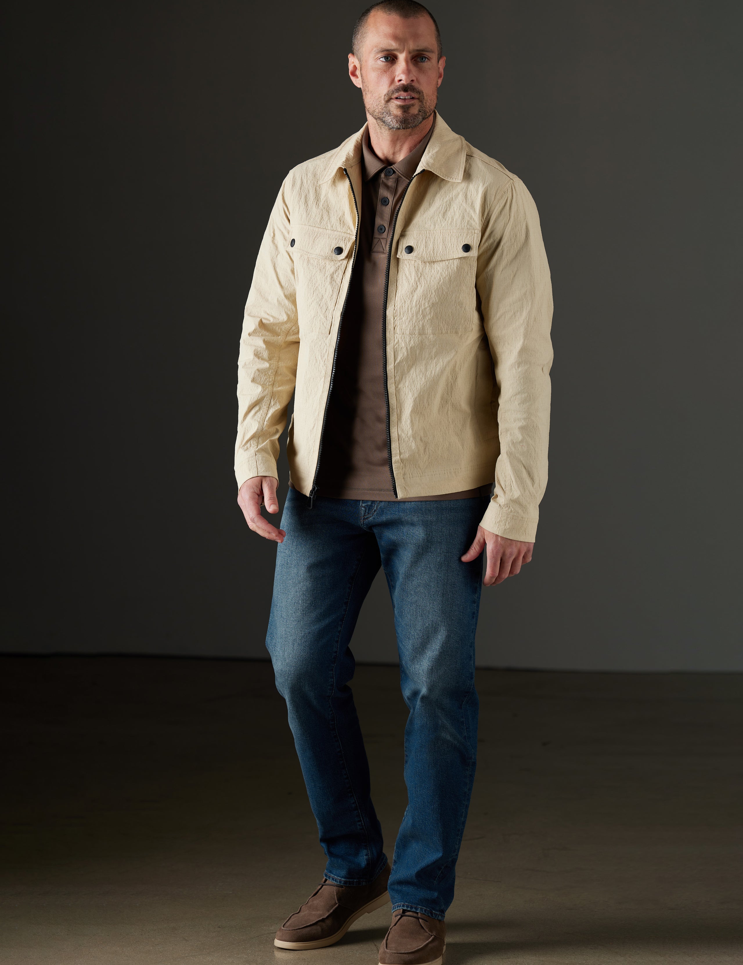 Front full-body view of man wearing Baxter Jacket in Desert Tan from AETHER Apparel.