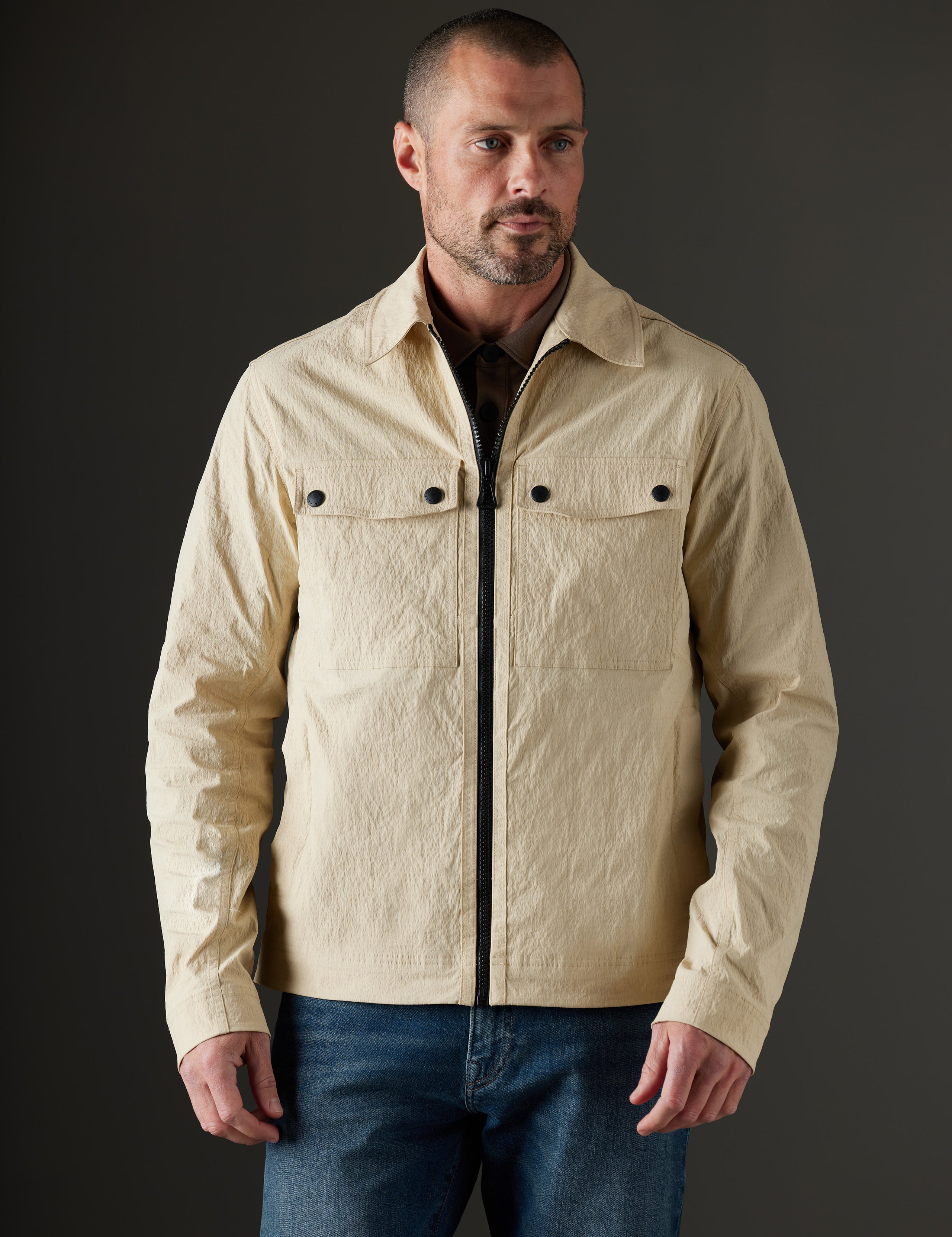 Front body view of man wearing Baxter Jacket in Desert Tan from AETHER Apparel.