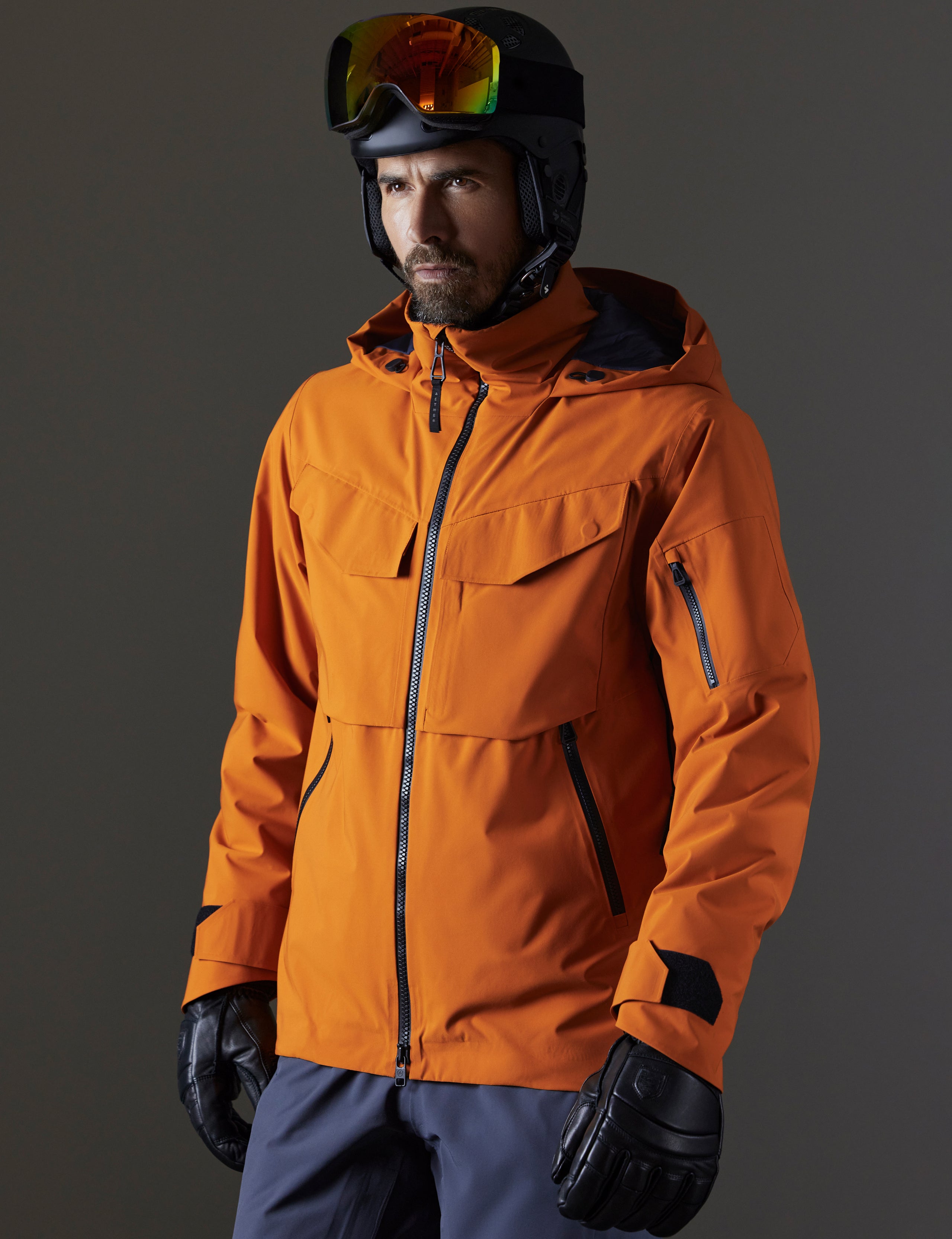 Front 3/4 body view of man wearing Brighton Insulated Snow Jacket in Autumn Orange from AETHER Apparel.