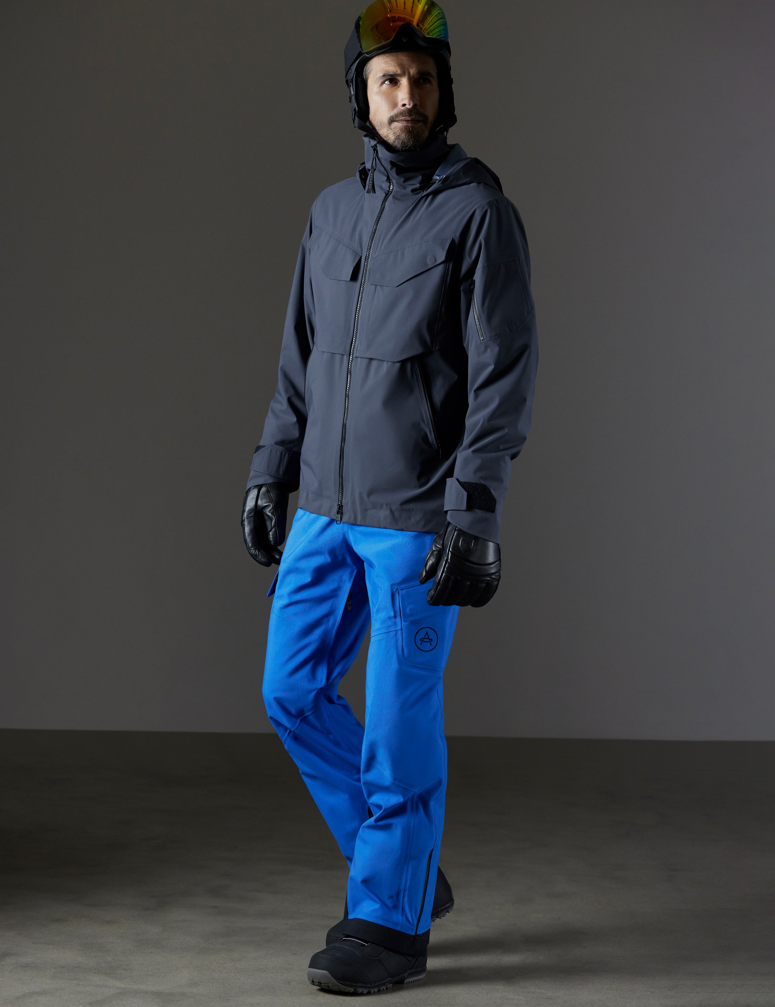 Front 3/4 full-body view of man wearing Brighton Insulated Snow Jacket in Graphite from AETHER Apparel.