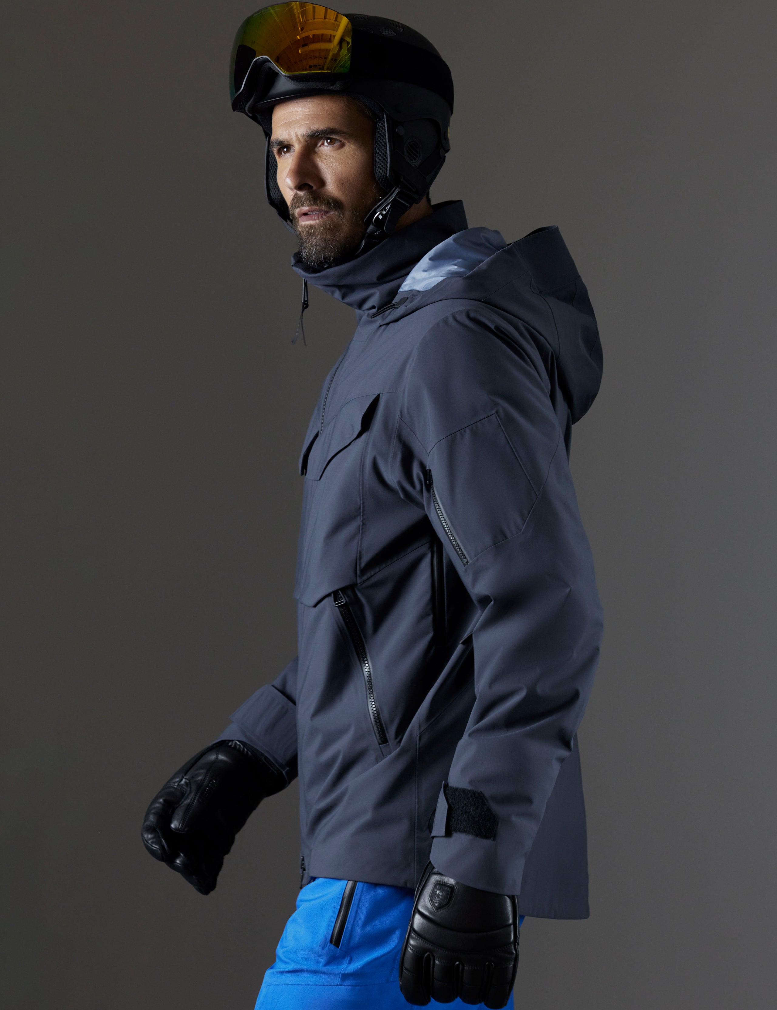 Side profile body view of man wearing Brighton Insulated Snow Jacket in Graphite from AETHER Apparel.