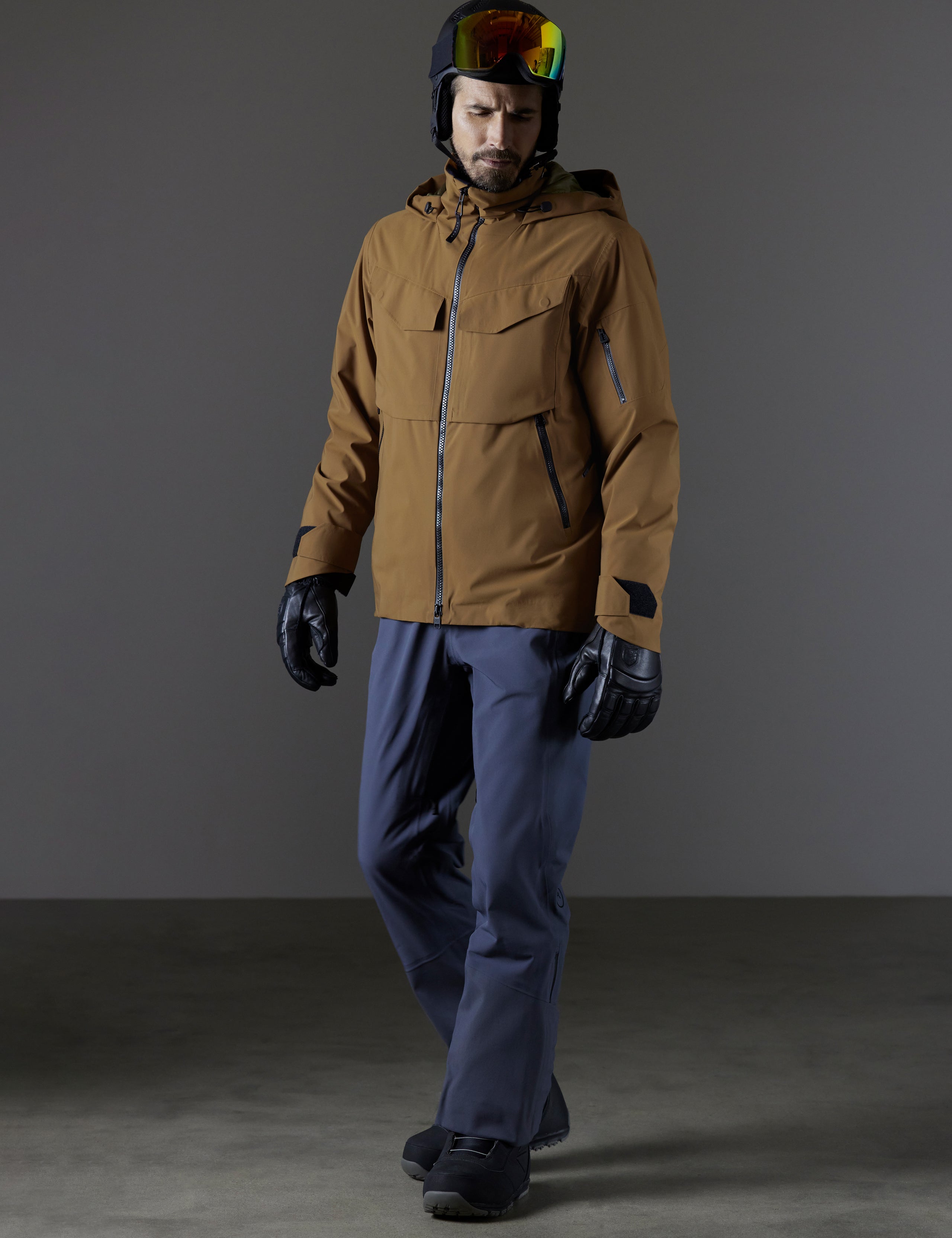 Front 3/4 full body view of man wearing Brighton Insulated Snow Jacket in Rubber Brown from AETHER Apparel.