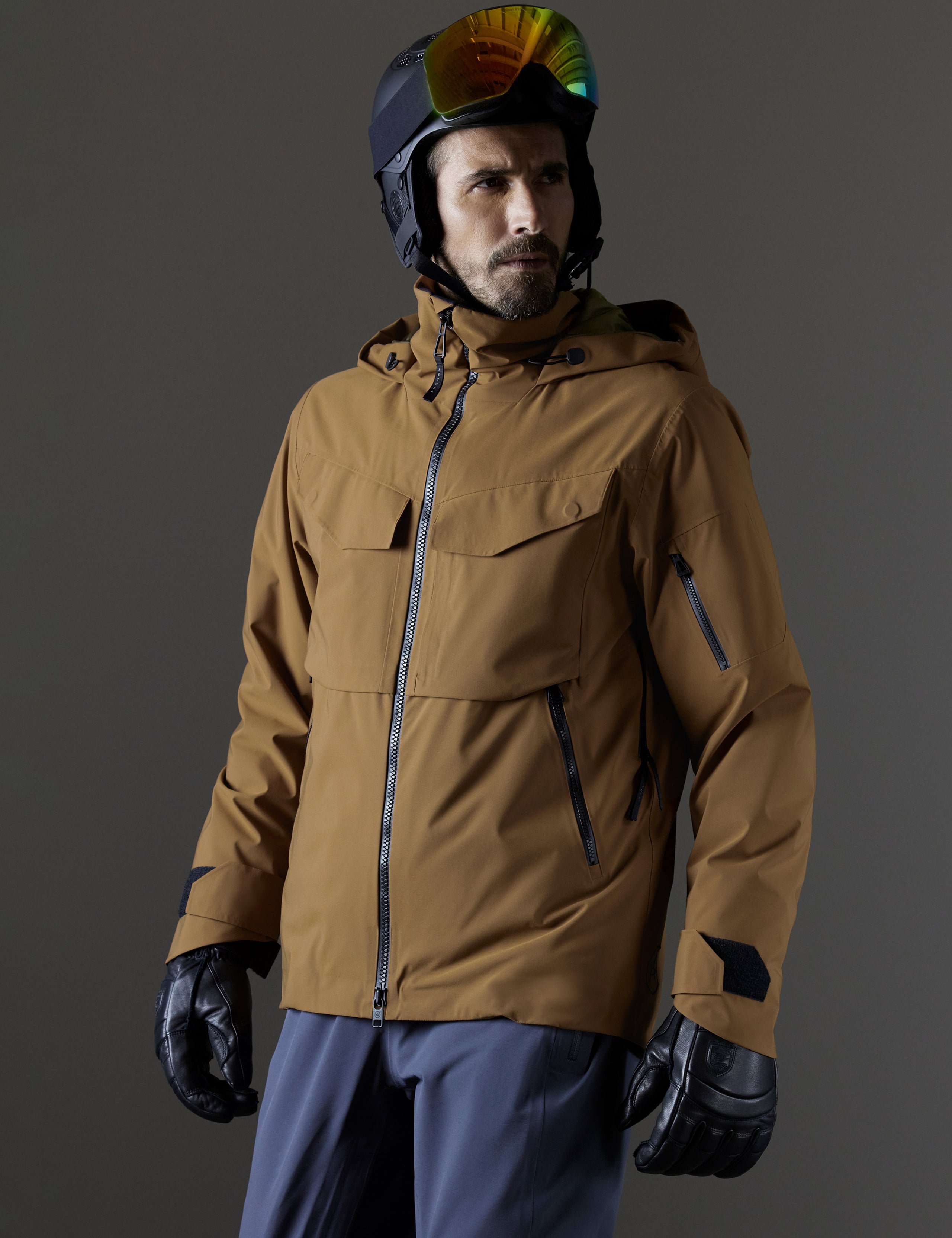 Front 3/4 body view of man wearing Brighton Insulated Snow Jacket in Rubber Brown from AETHER Apparel.