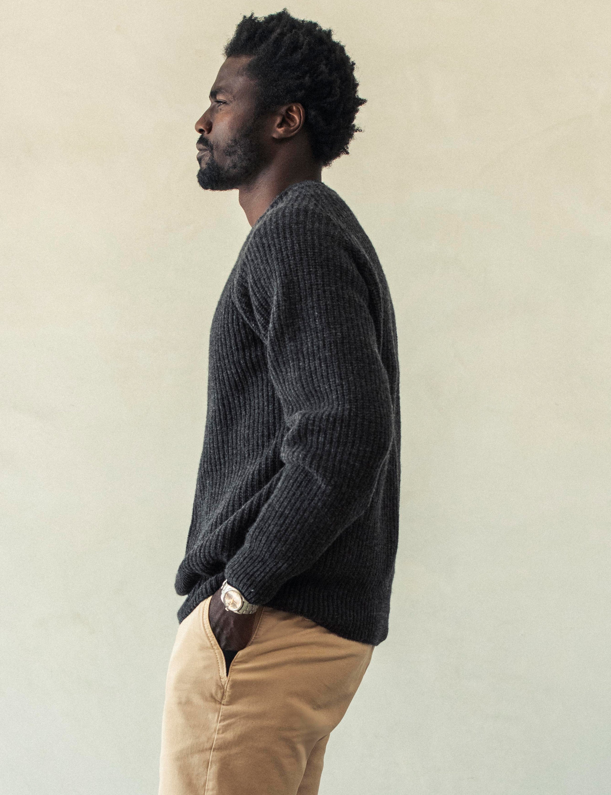 Side profile body view of man wearing Camden Crewneck Sweater In Charcoal Heather from AETHER Apparel.