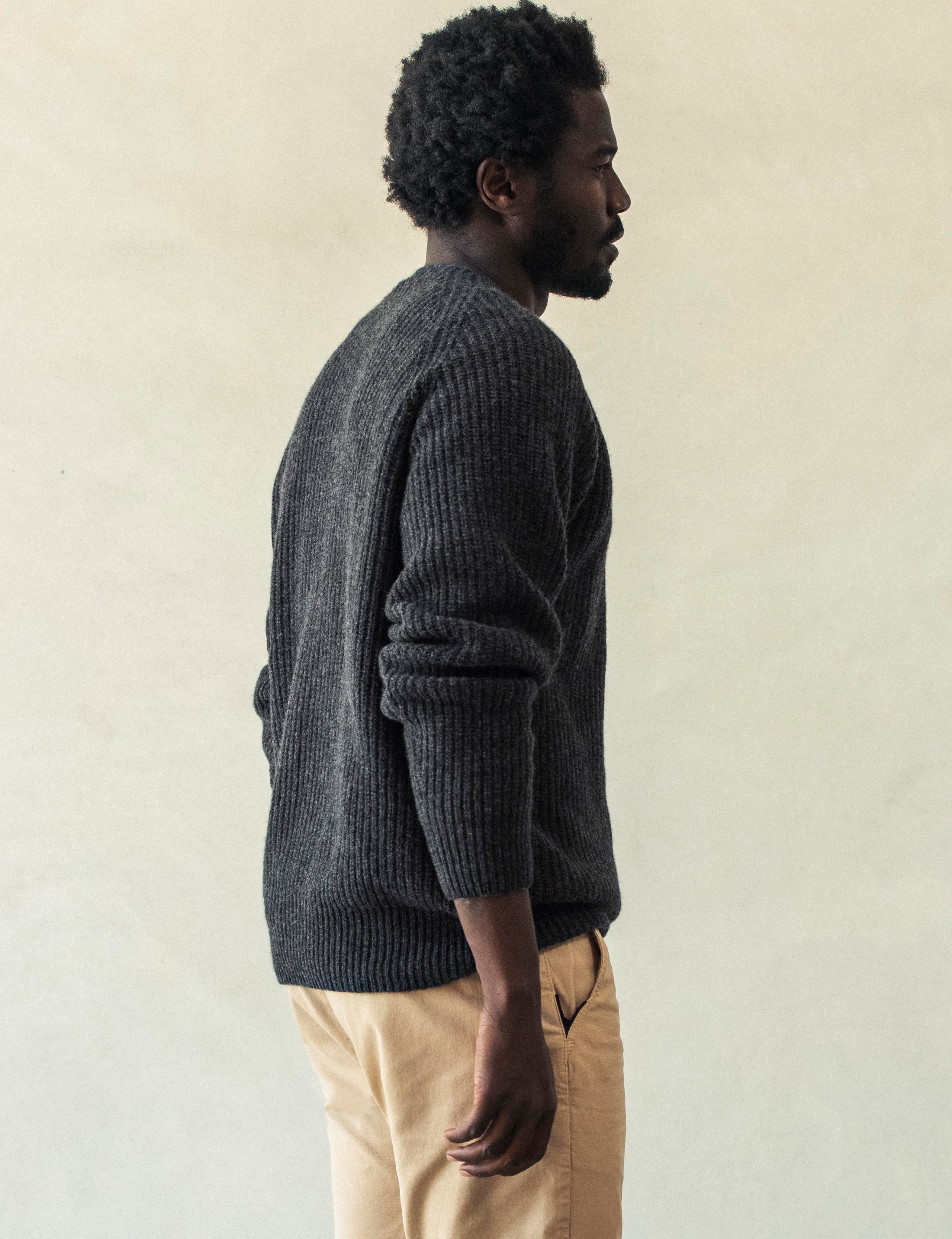Rear 3/4 body view of man wearing Camden Crewneck Sweater In Charcoal Heather from AETHER Apparel.