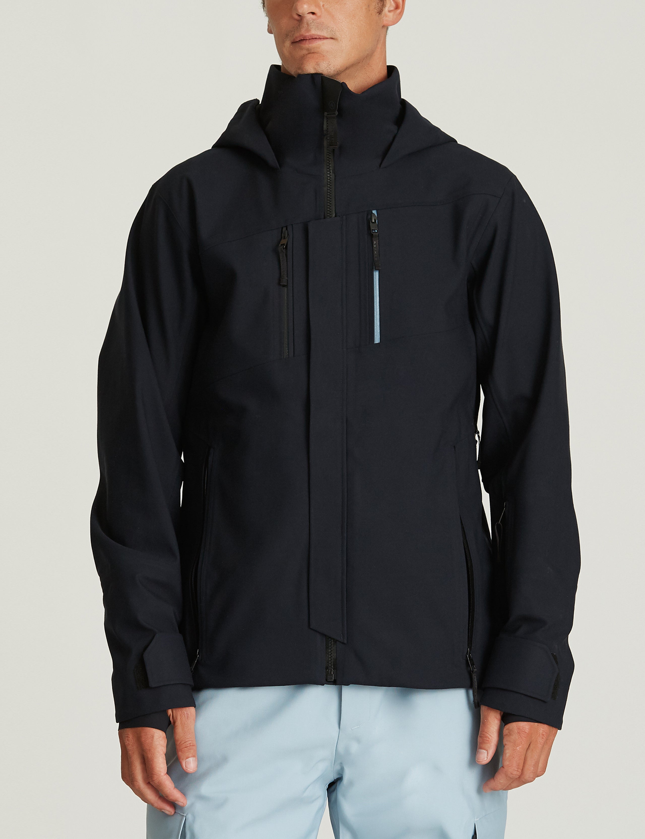Front body view of man wearing Catalyst Snow Shell in Total Eclipse dark blue from AETHER Apparel.