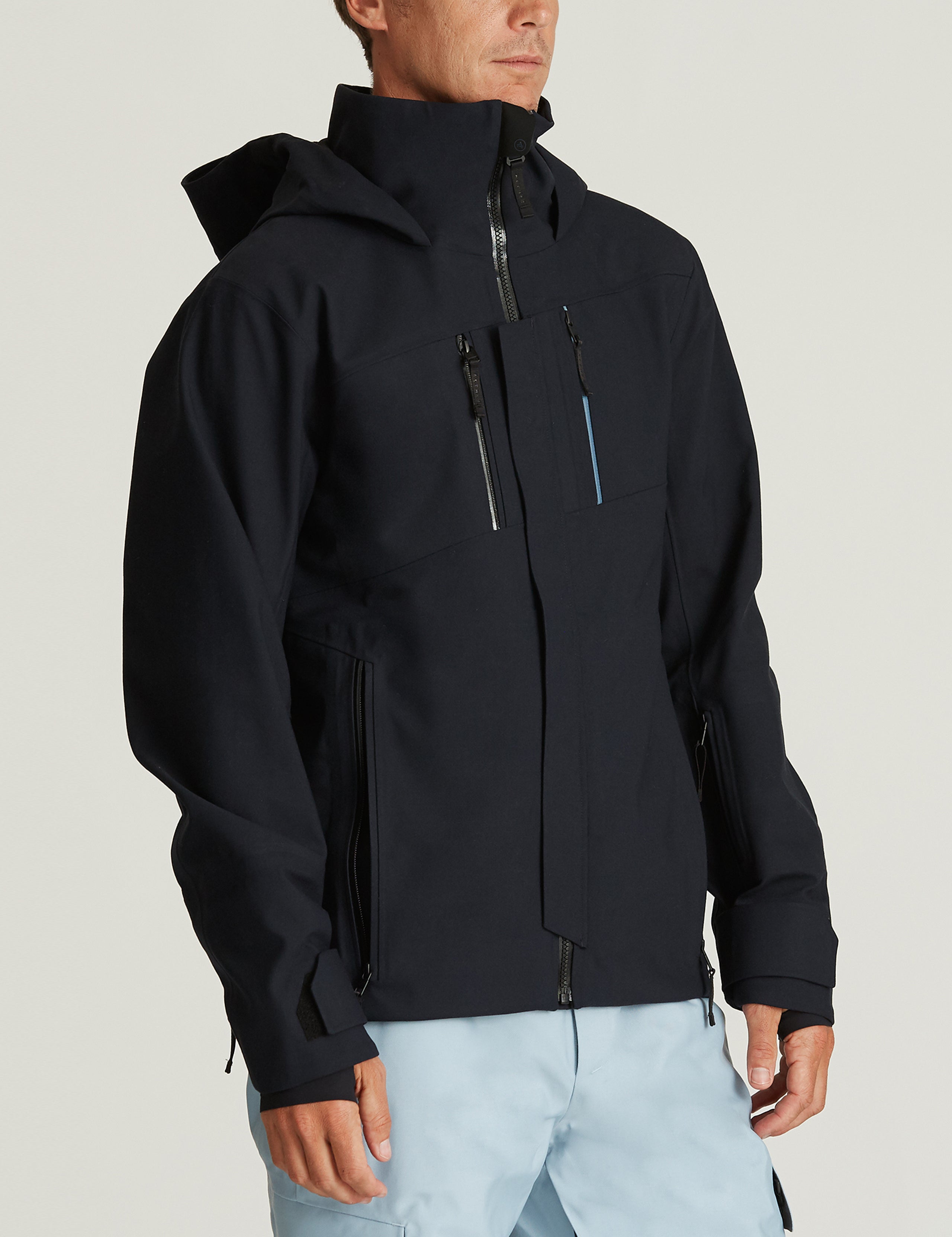 Front 3/4 body view of man wearing Catalyst Snow Shell in Total Eclipse dark blue from AETHER Apparel.