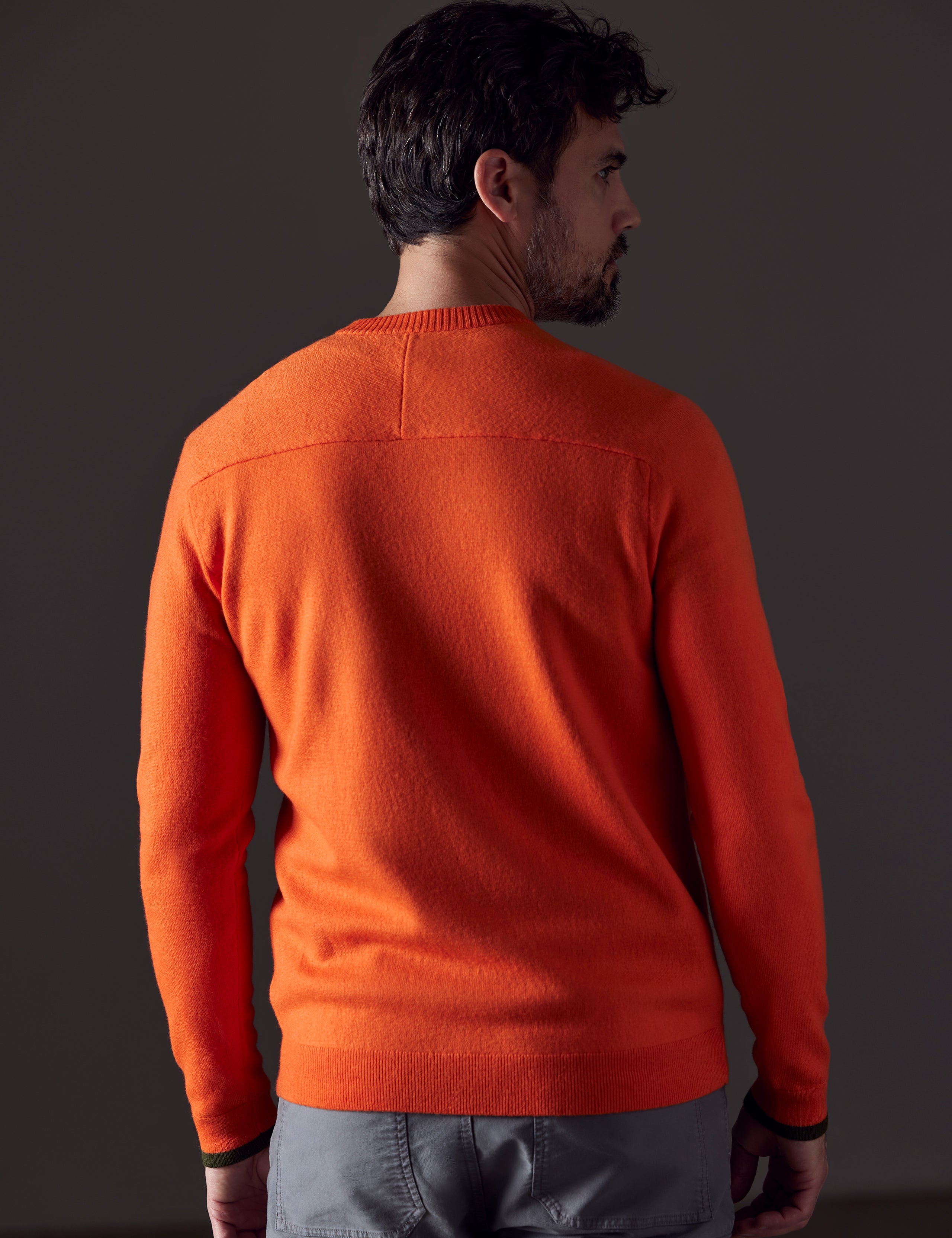 Rear body view of man wearing Corbin Sweater in Sedona Orange from AETHER Apparel.