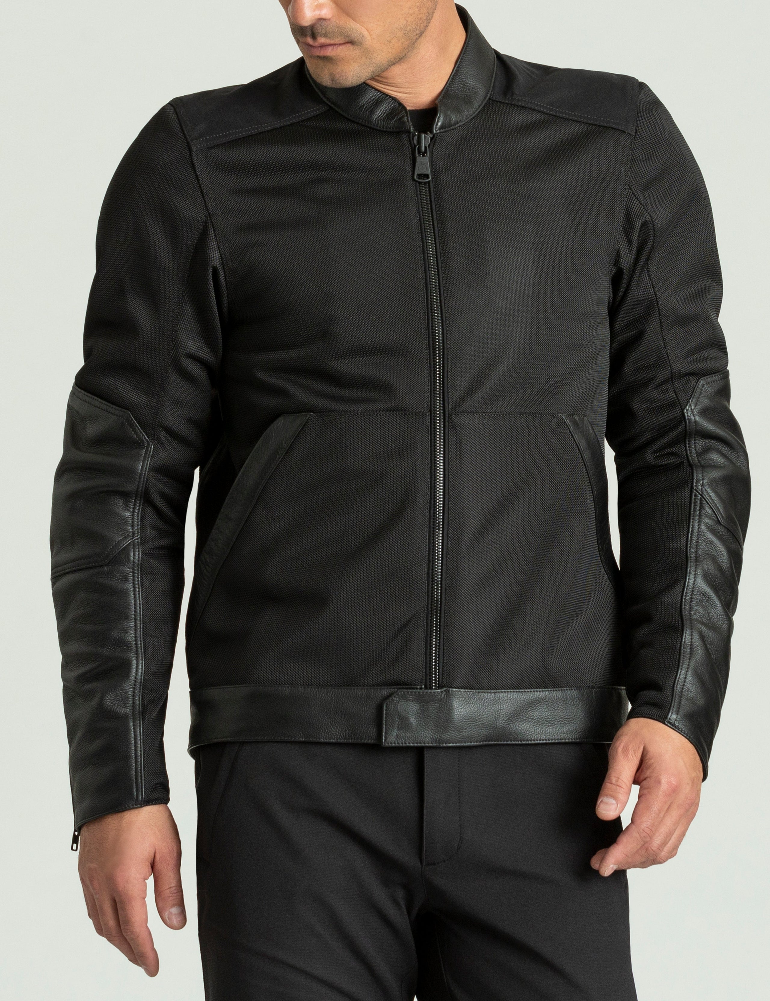 Front body view of man wearing Draft Mesh Motorcycle Jacket in Jet Black from AETHER Apparel.