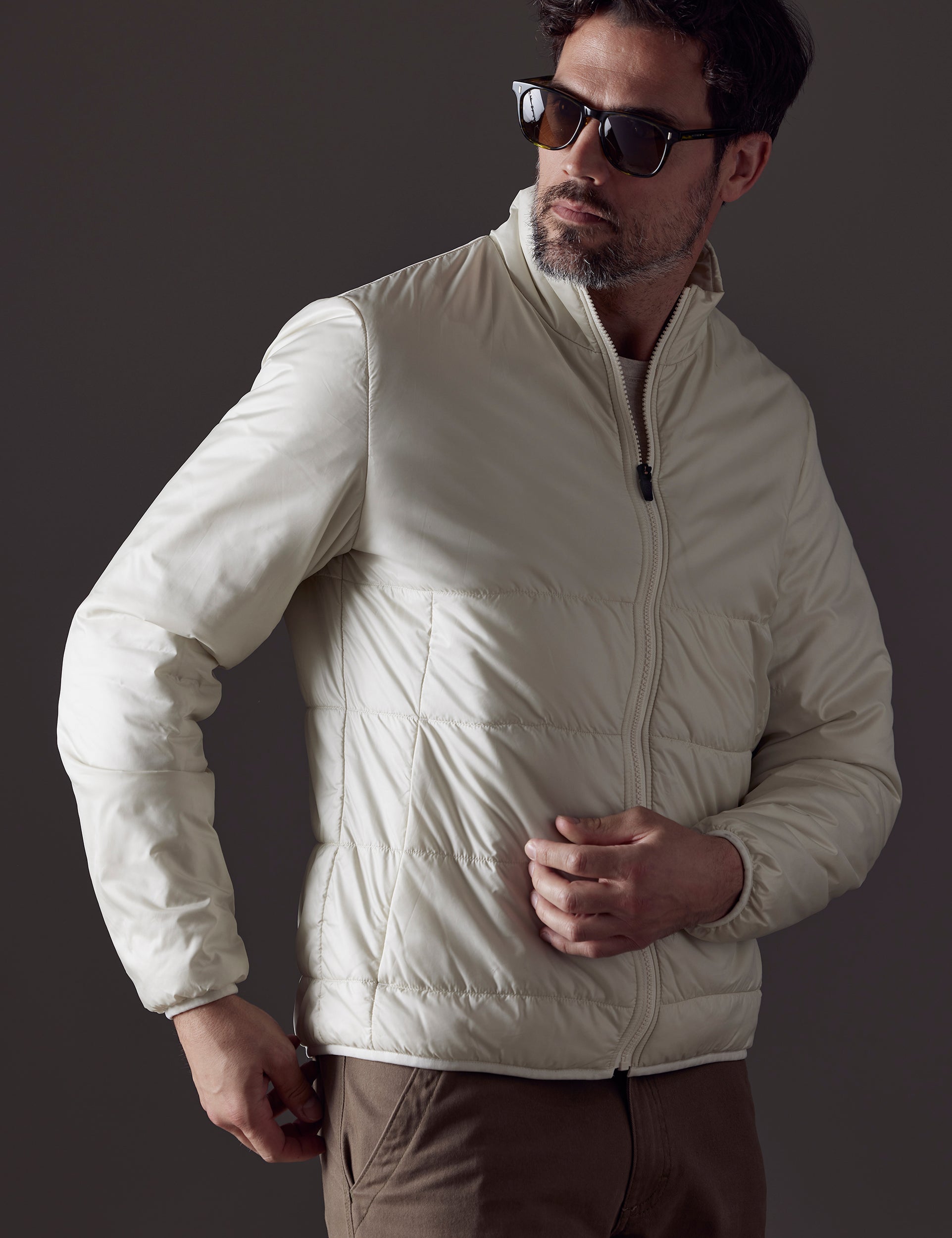 Front 3/4 body view of man wearing Eco Insulated Jacket in Winter White from AETHER Apparel.